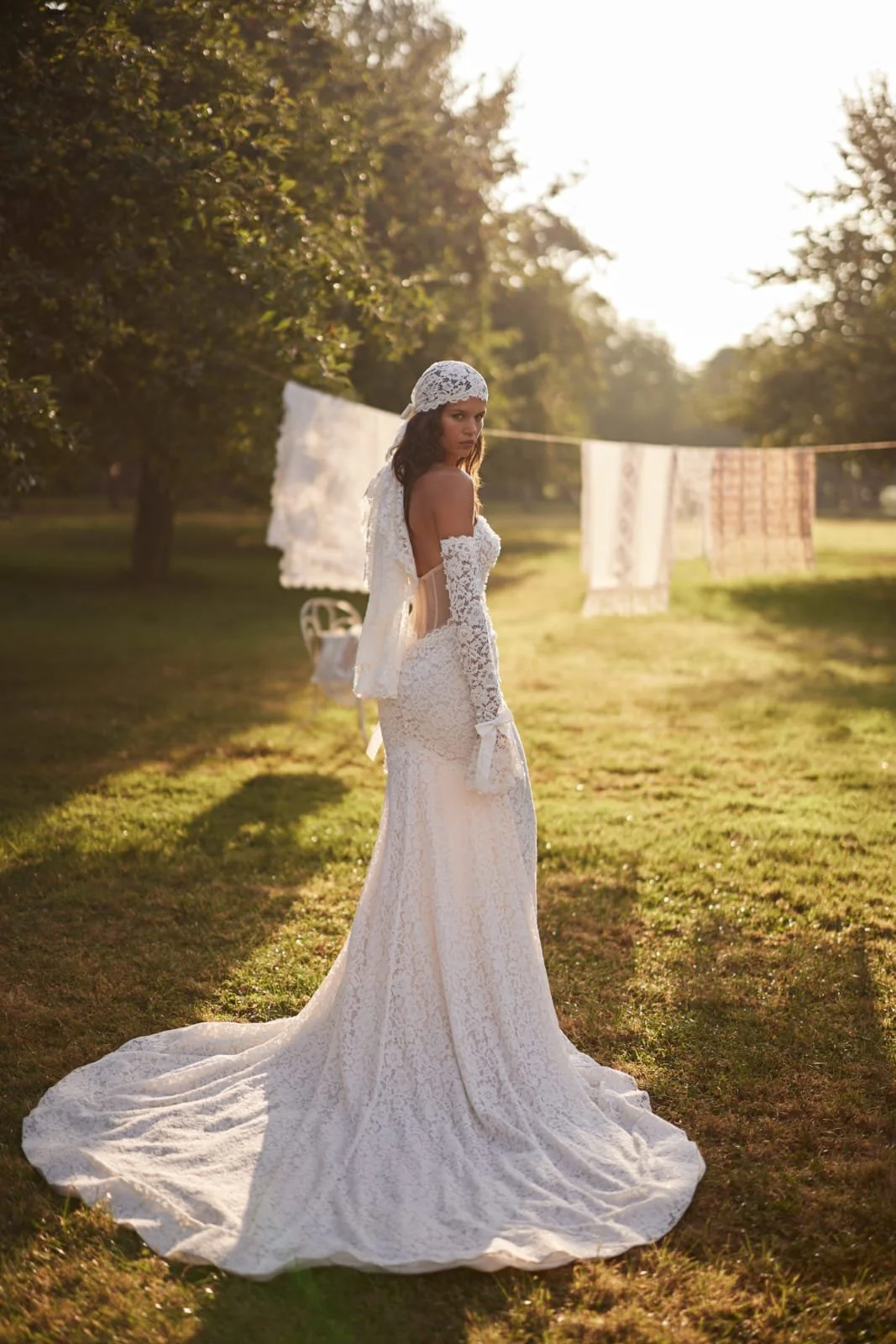 Side view of LunaRose Chantilly lace mermaid bridal gown highlighting fitted silhouette and flowing train