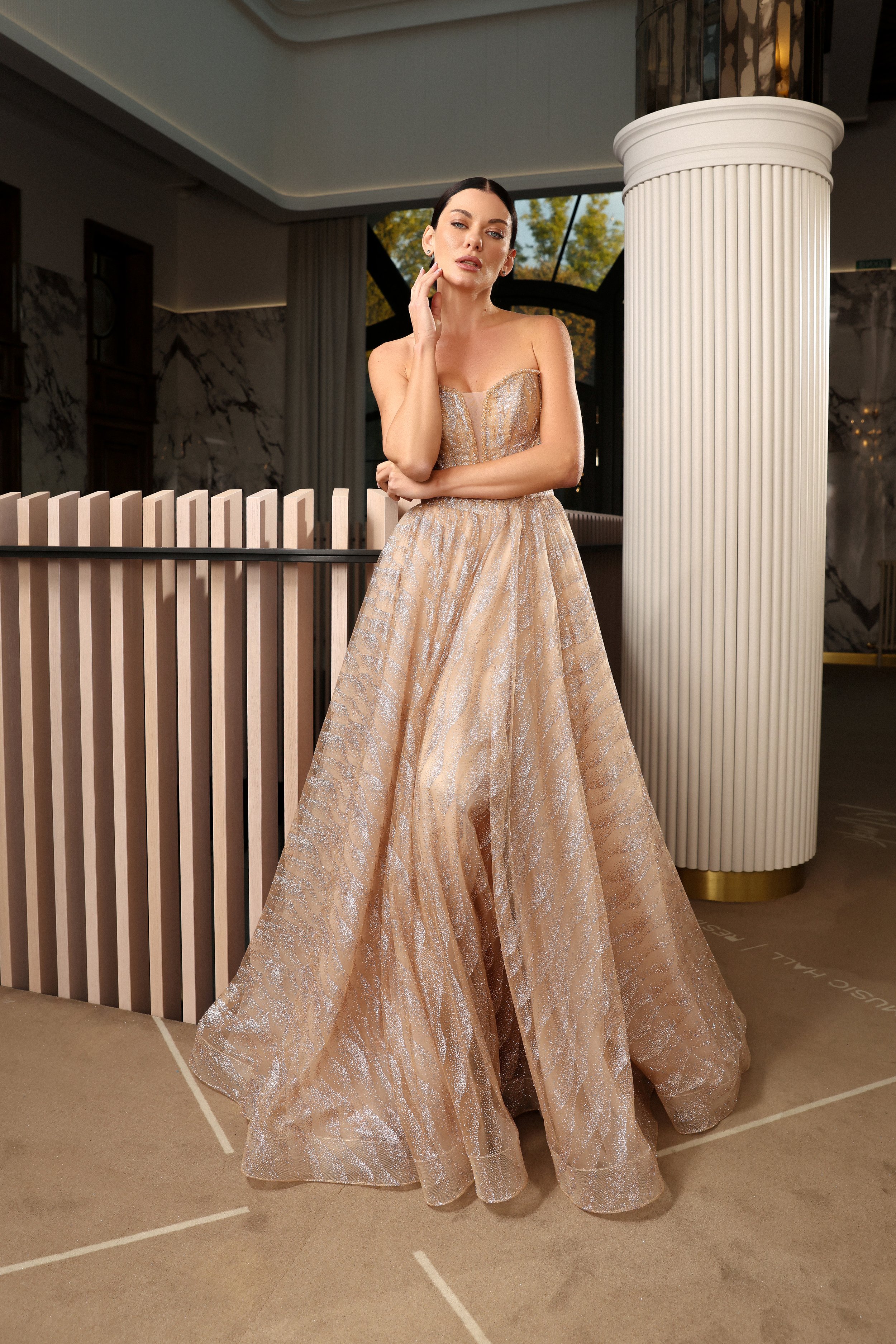 Luxurious gold glitter tulle evening gown with shimmering details and an elegant silhouette.