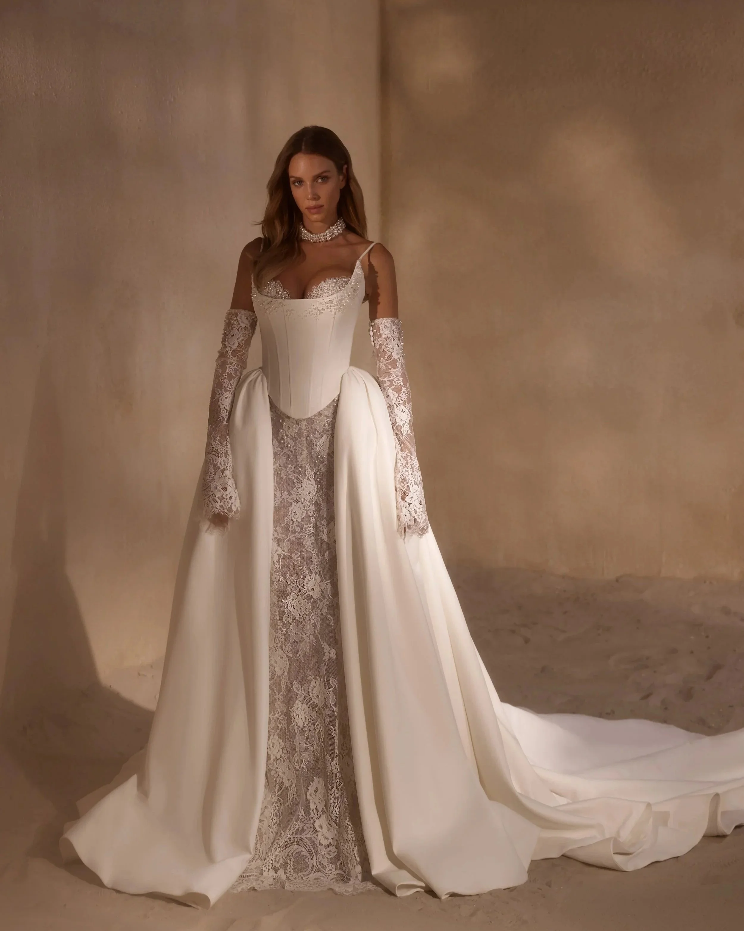 A transformer wedding dress, Adisa by Luce Sposa, Lace mermaid dress with a satin corset and overskirt. Lace sleeves for the final touch.