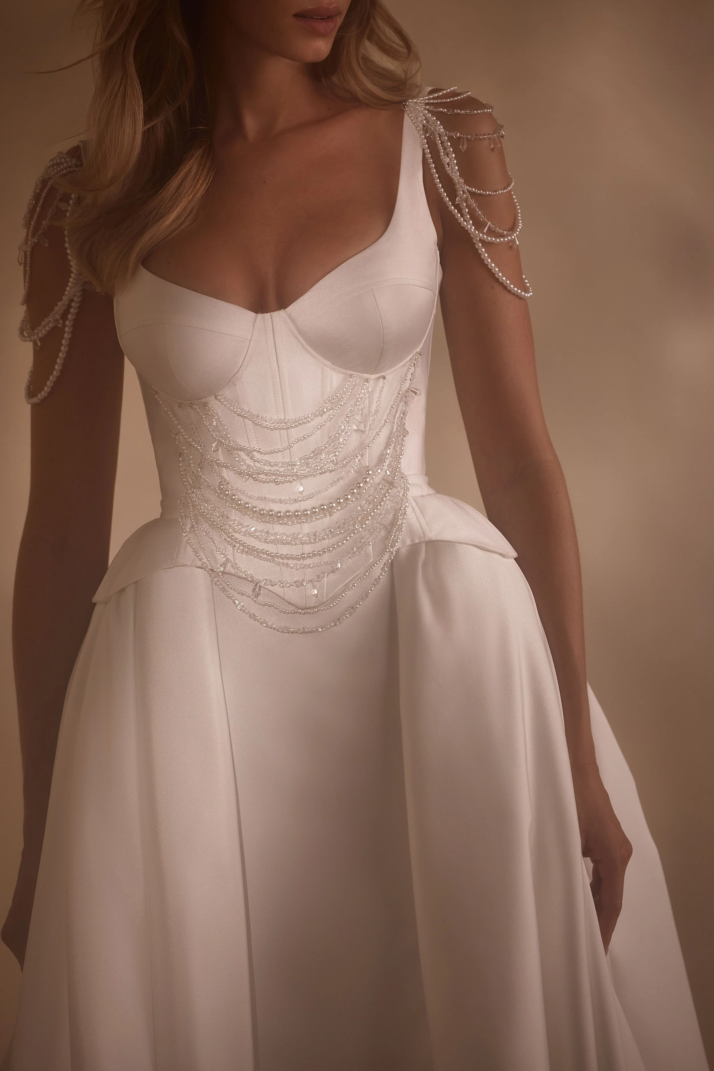 he Medina gown, a Mikado mermaid wedding dress with crystal-embroidered bodice, flattering neckline, and minimalist skirt with train