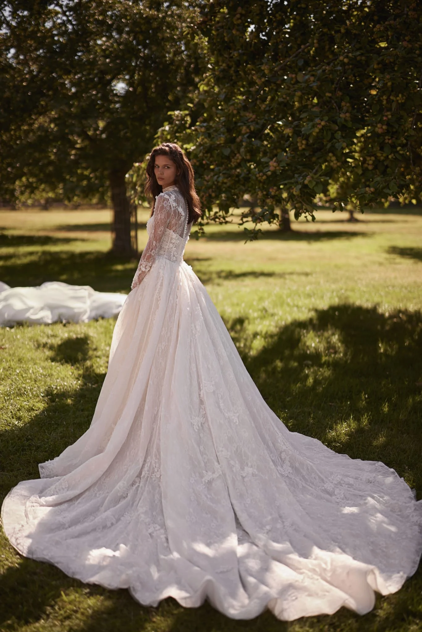 Back view of Liv Chantilly lace bridal gown with zipper and corset lacing and long lace train