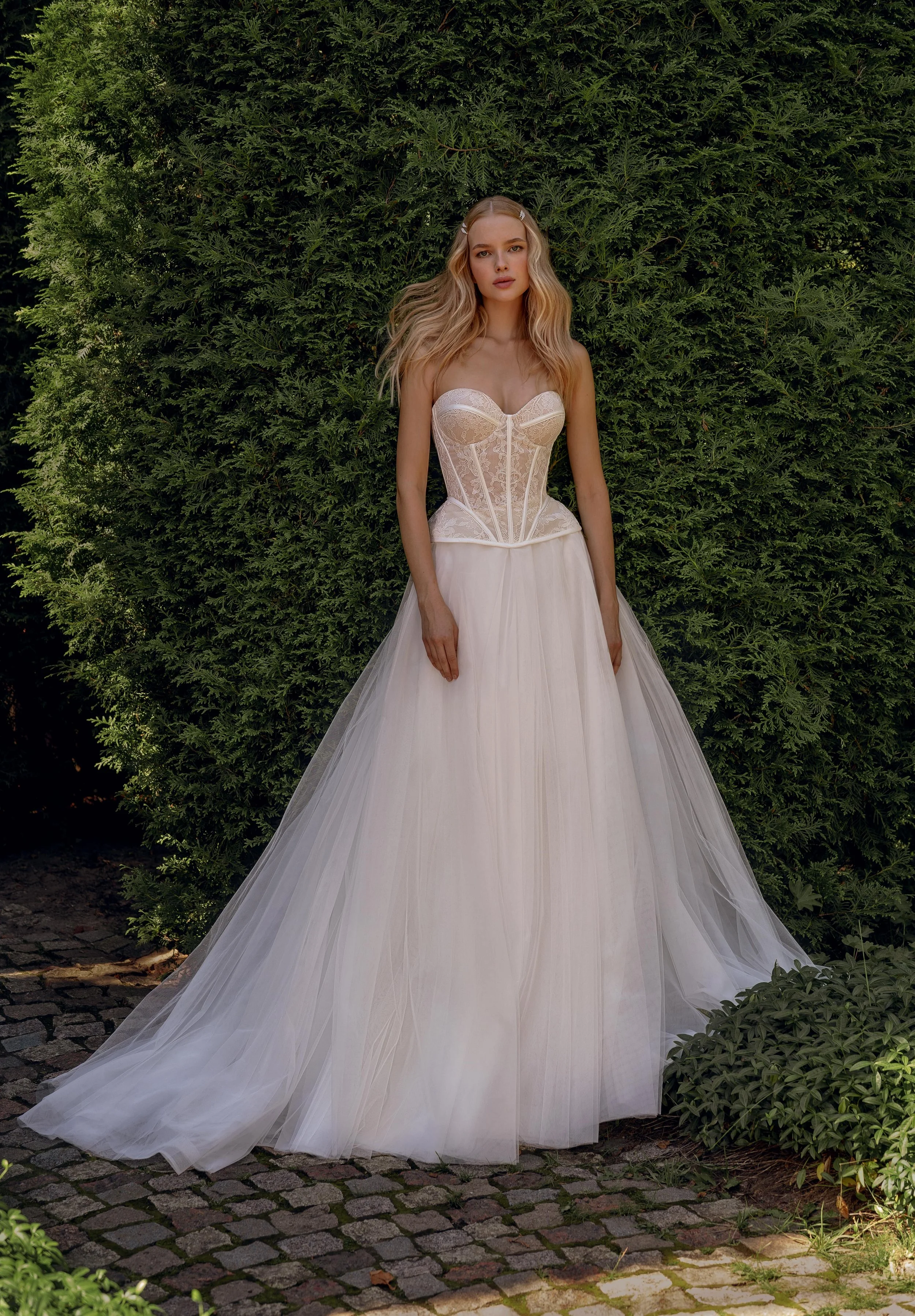 Front view of the Gvendolin two-piece wedding dress featuring a flowing tulle skirt and sweetheart lace corset.