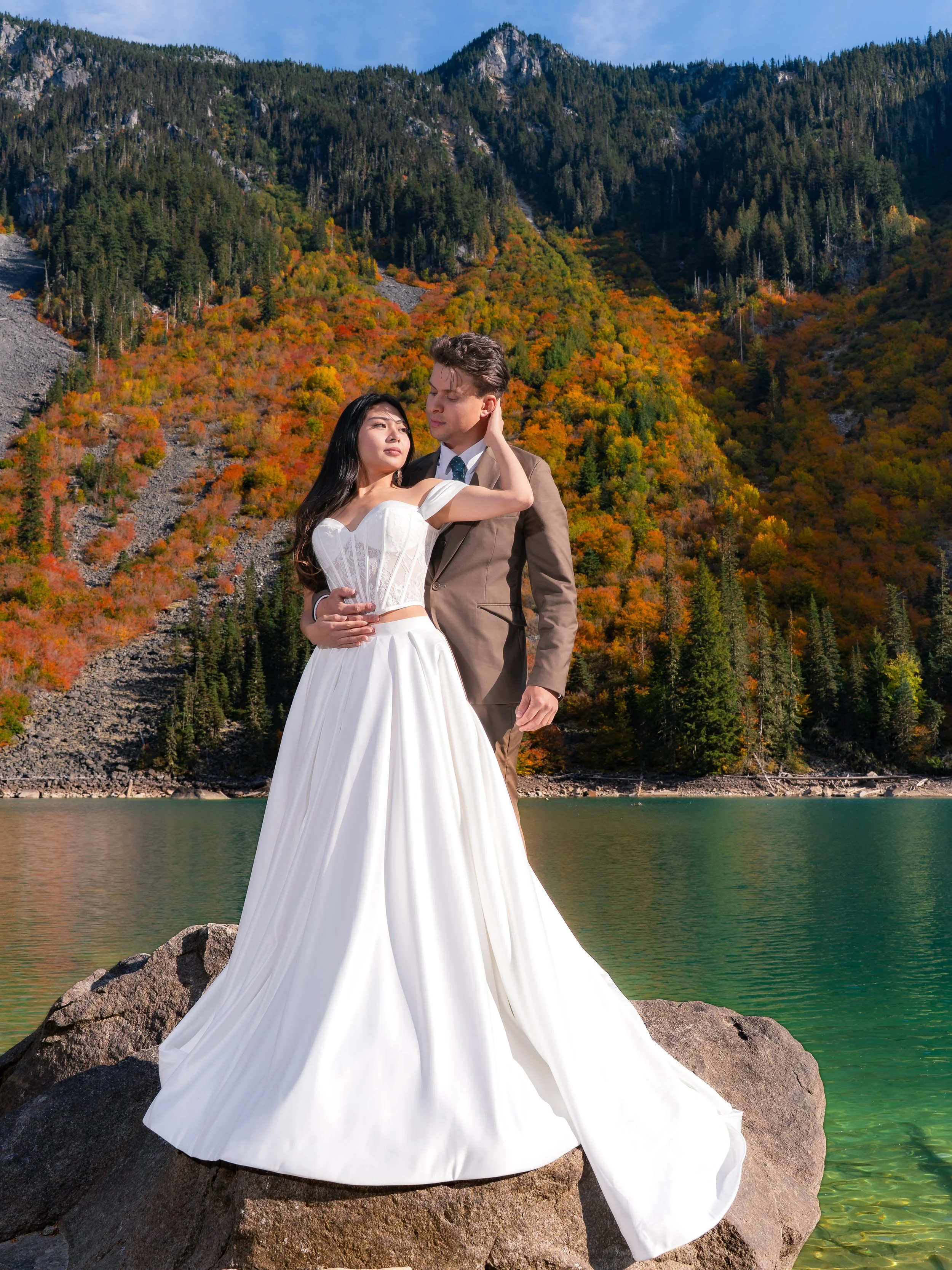 Bride in an A-line wedding dress, sweetheart corset with Satin skirt, with her groom and a forest background.