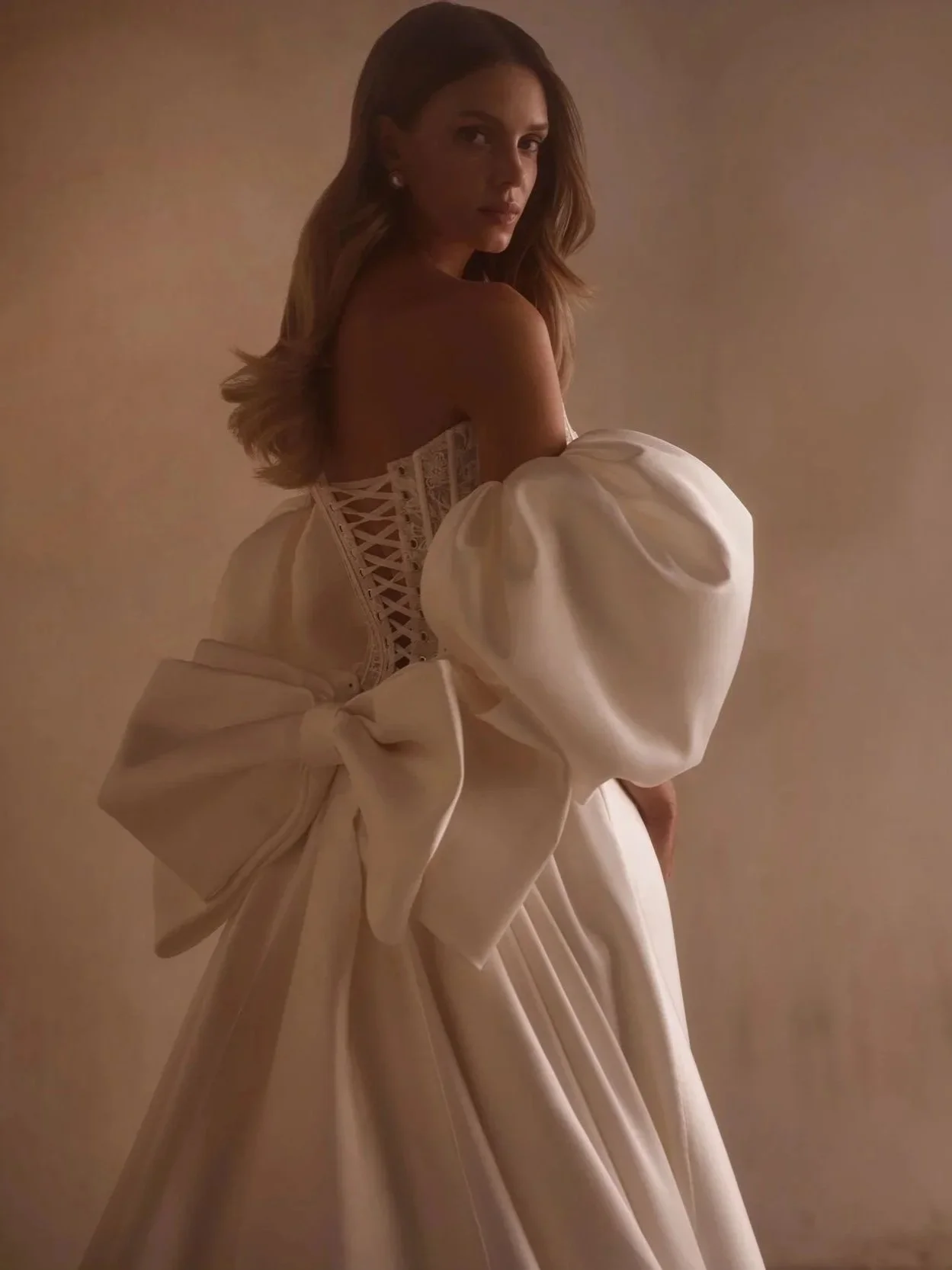 Ashera by Luce Sposa, wedding dress with a structured bow and back corset threaded, Satin