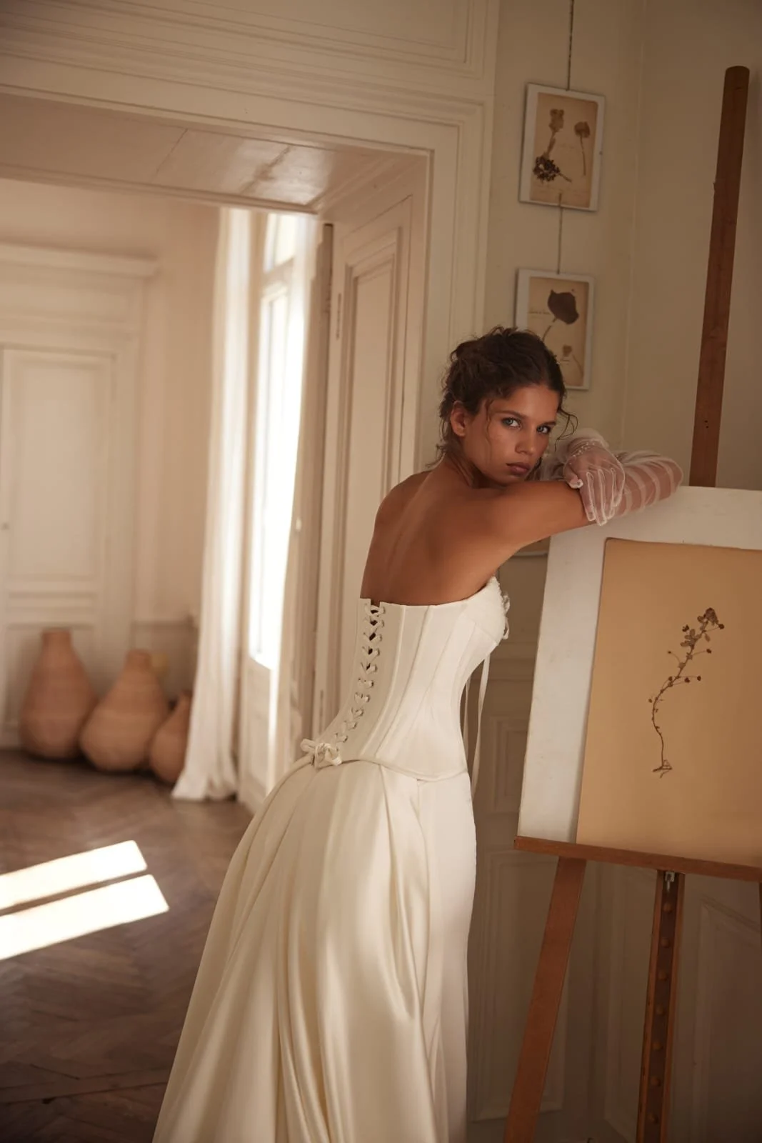 Back view of the Poesie transformer wedding gown with lace-up bodice and smooth satin skirt