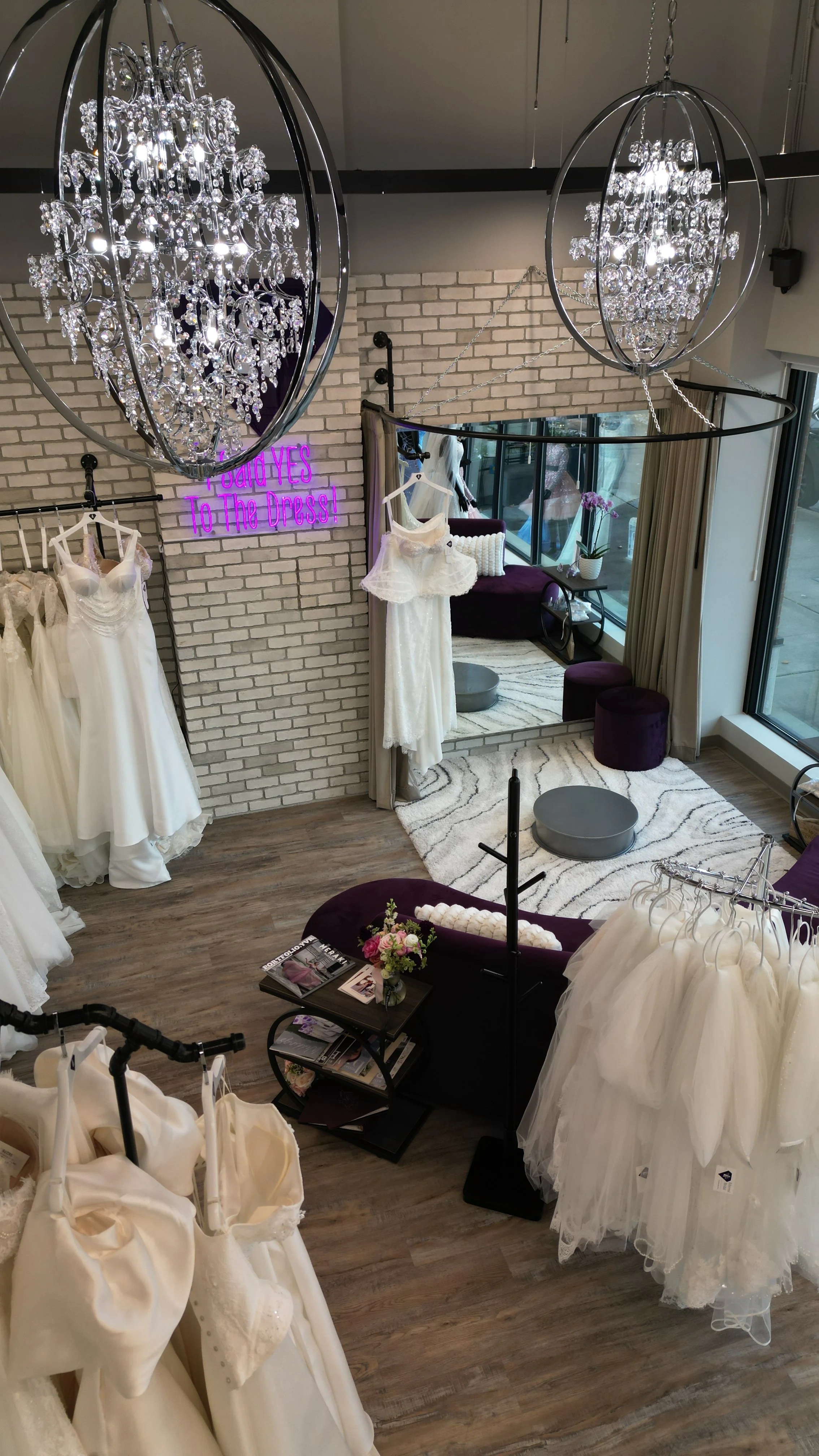 Inside of Ethereal Bridal Boutique in Port Moody, Racks with wedding dresses, sitting area and fitting room.