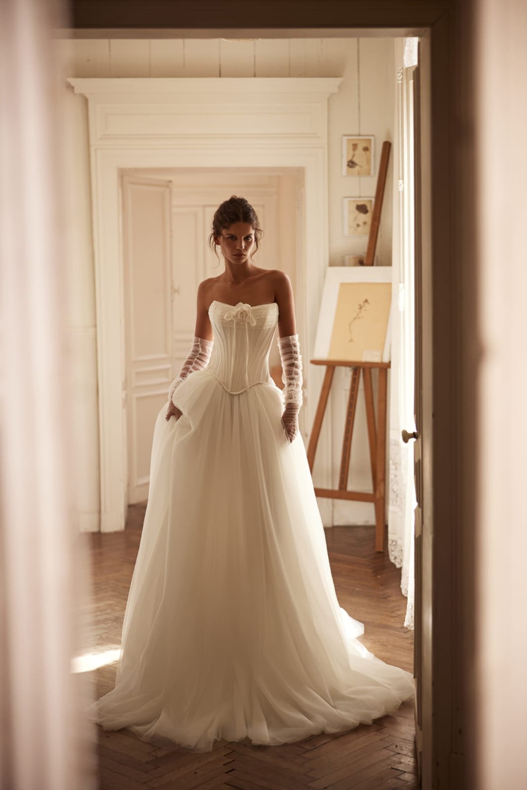 Detail of minimalist tulle skirt flowing into a small train on the Poesie wedding gown