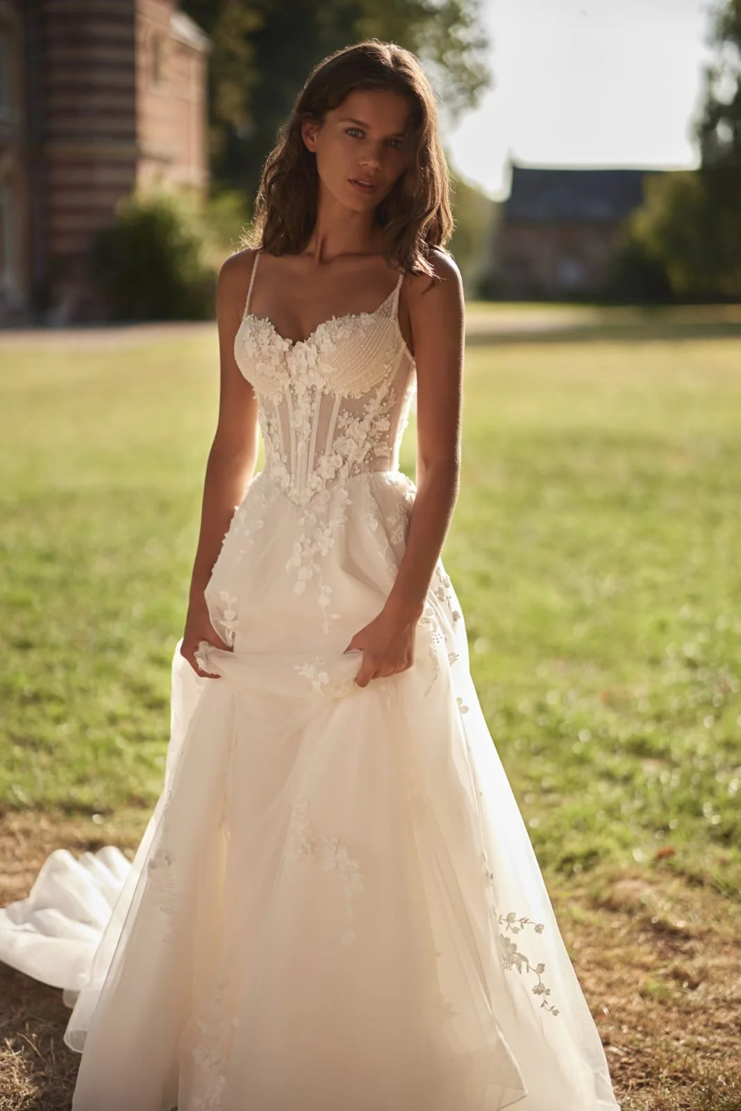 Side view of Epine bridal gown highlighting airy mesh and organza skirt and flowing silhouette