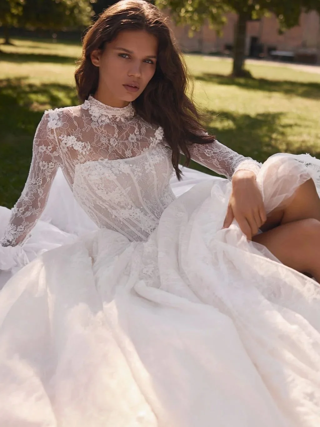 The Liv wedding gown pairs a nude Chantilly lace silhouette with couture embroidery and an elegant long train.