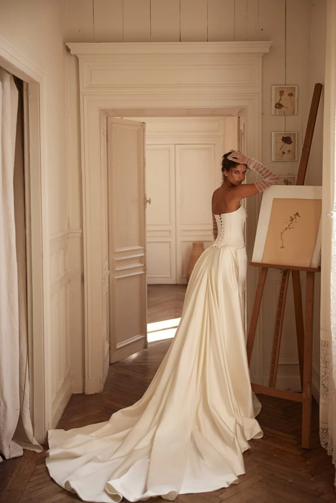 Side view of Poesie satin bridal gown highlighting clean silhouette and subtle train