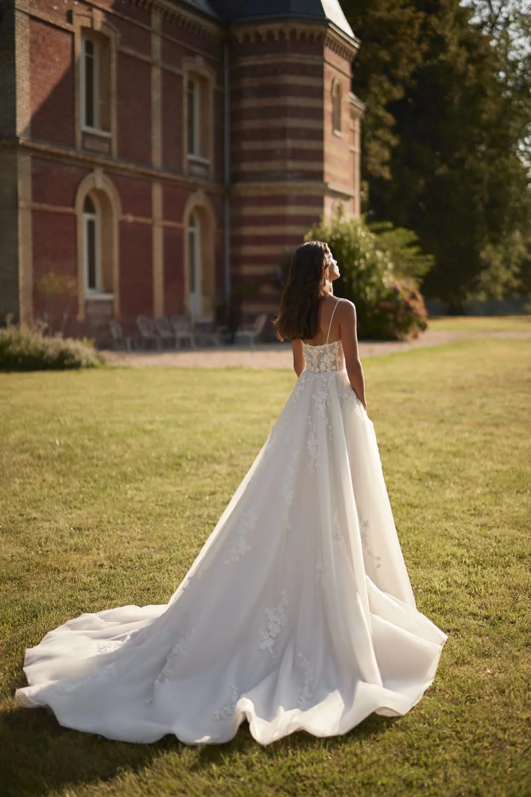 Detail of mesh and organza bridal skirt with lace floral appliqués on the Epine gown