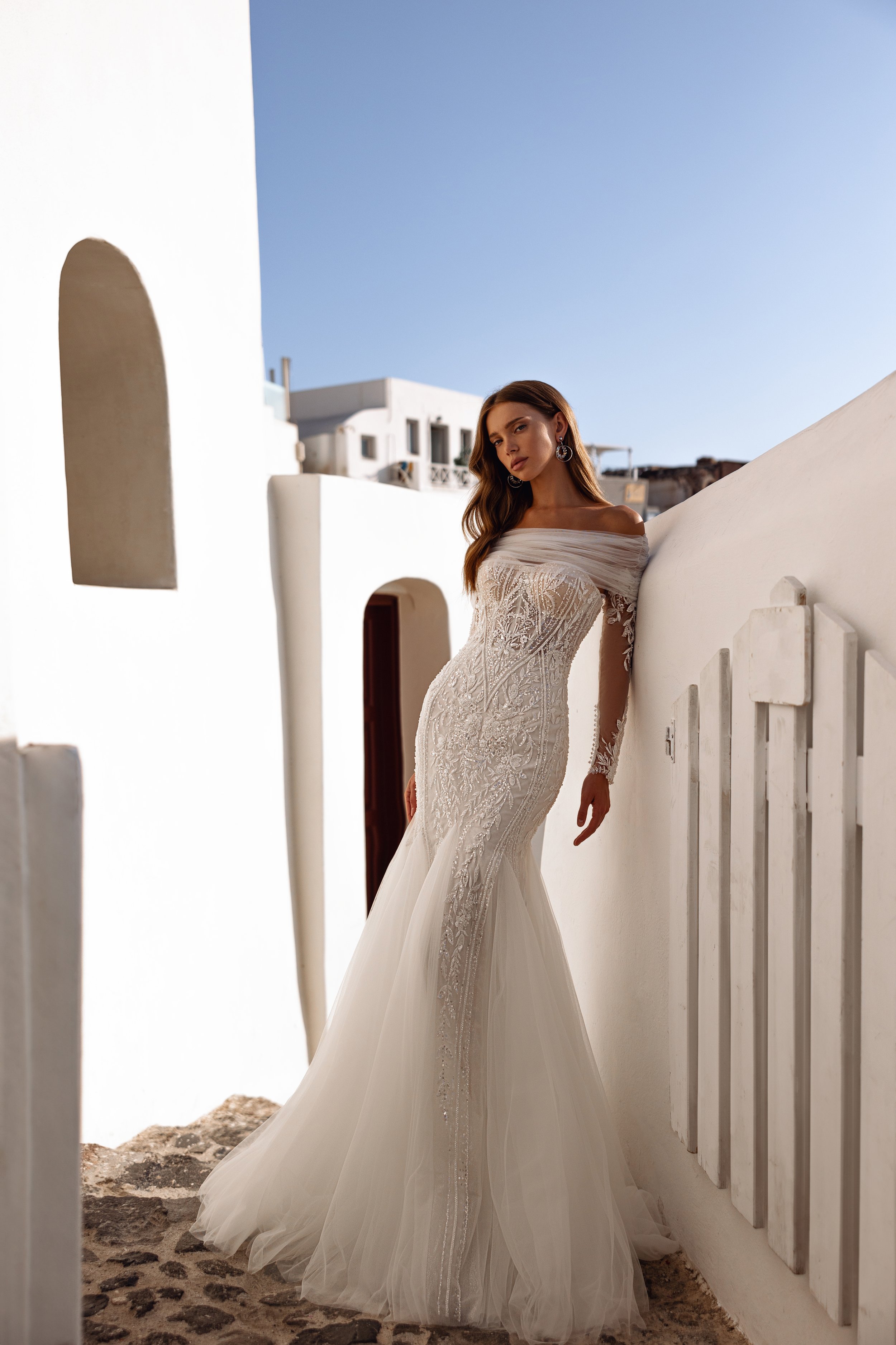 Beaded mermaid wedding gown with sweetheart neckline, fitted silhouette, and detachable matching sleeves.