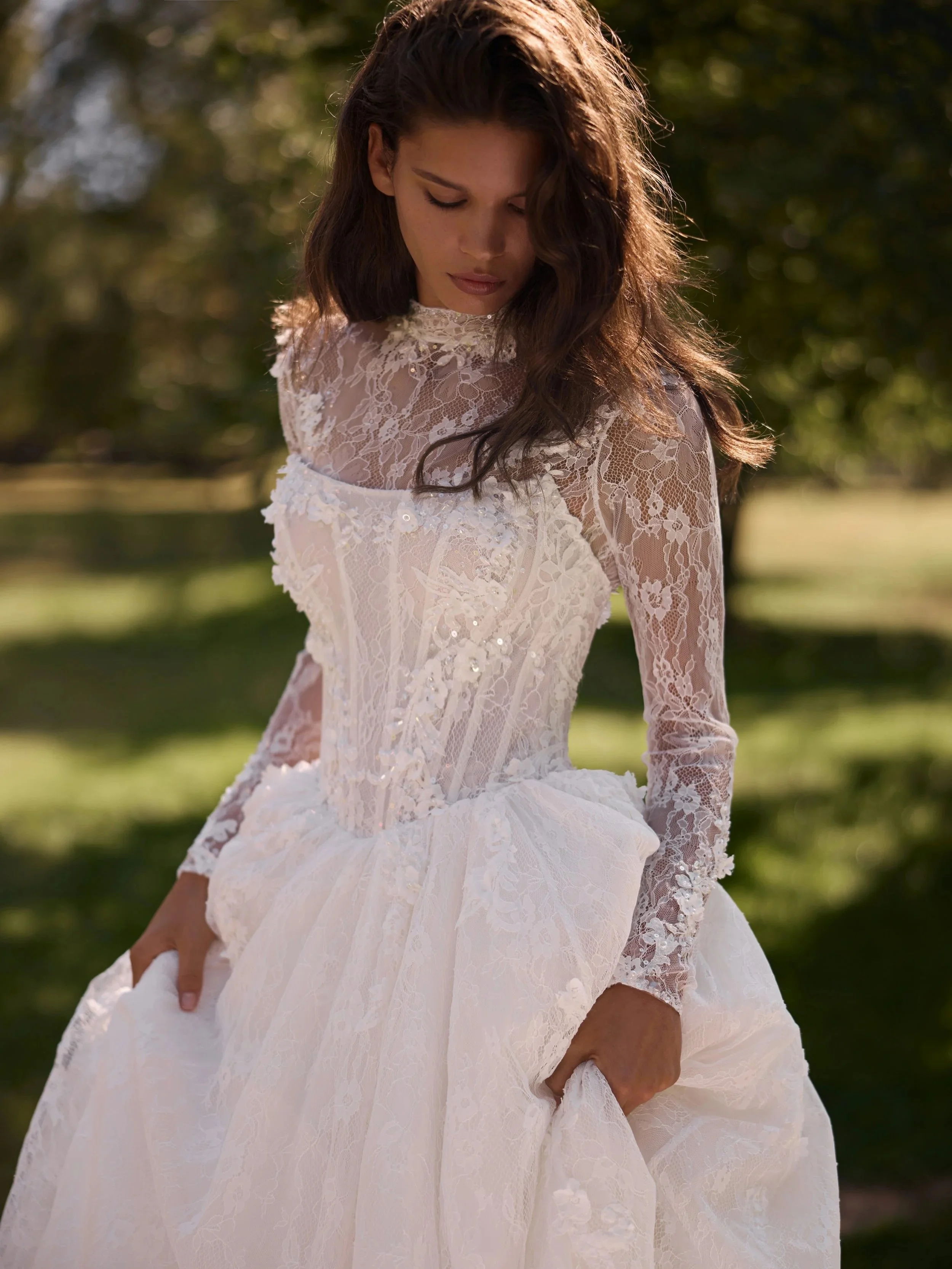 Close up a Liv wedding gown by Luce Sposa, basque waist lace with a full sleeve optional bolero.