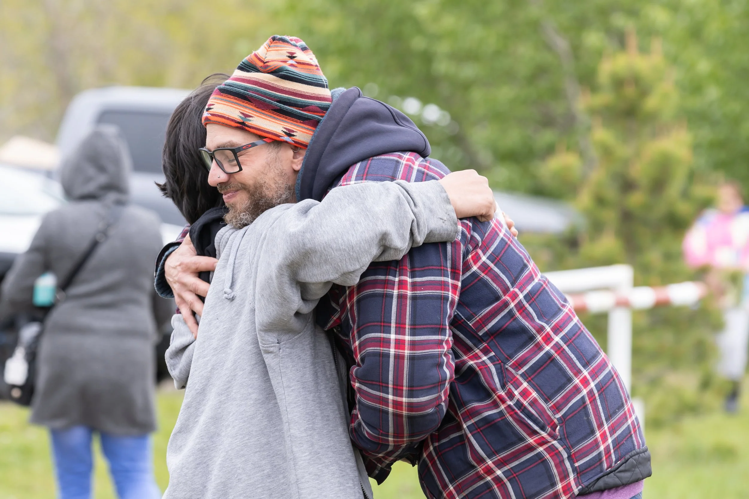 Two people hug warmly.