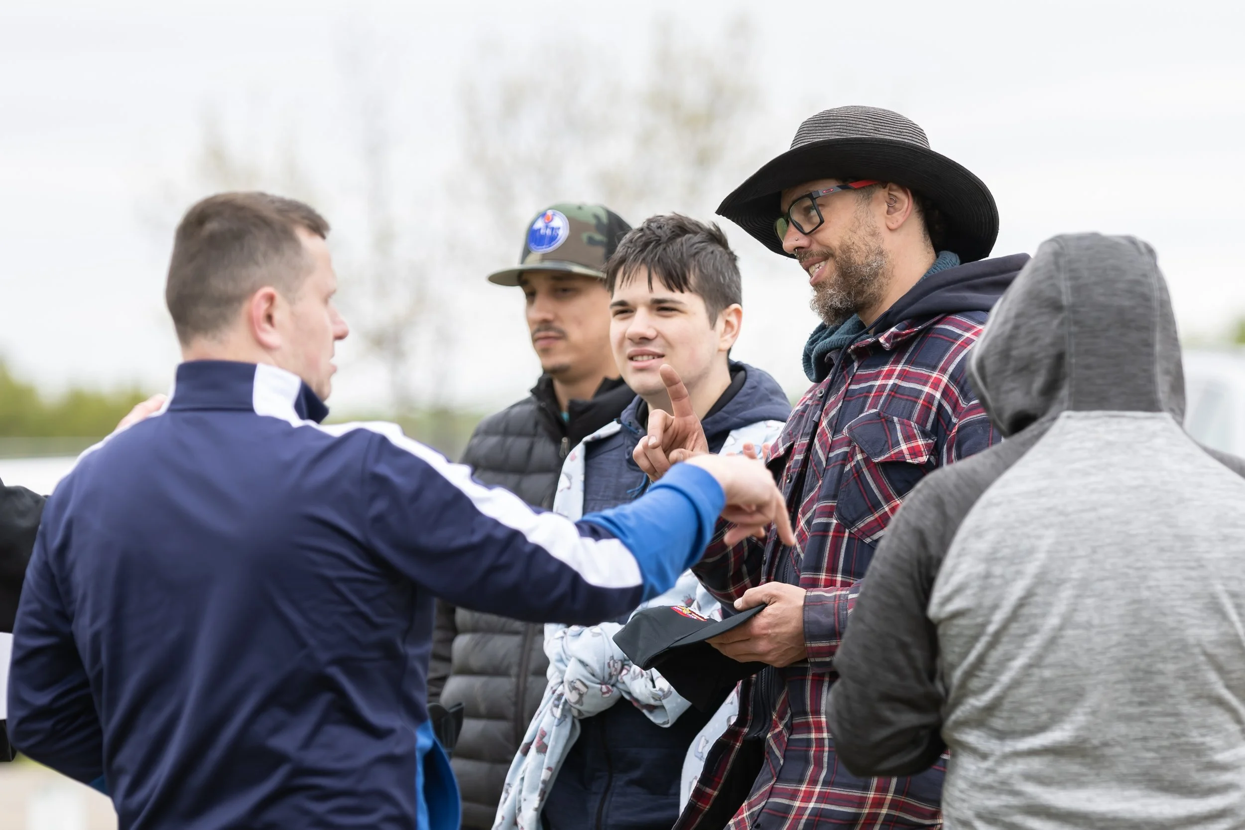 A small group of of folks converse.