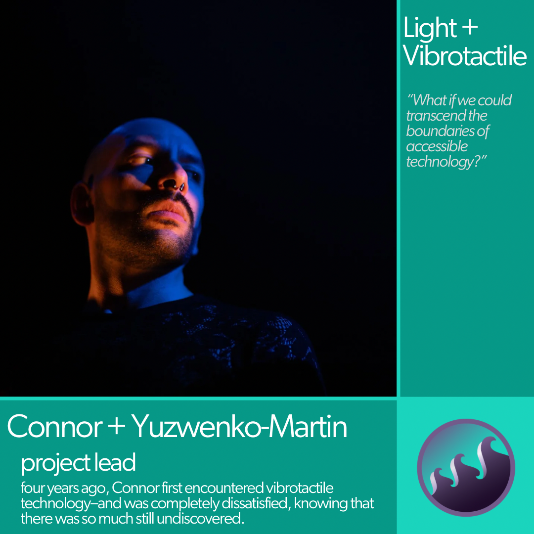 Connor’s face is starkly lit from the sides in a dark space, in tones of blue and light pink. He is looking to one side at an angle with a solemn expression. He is a young white man with neatly trimmed beard and a small silver bull nose ring.