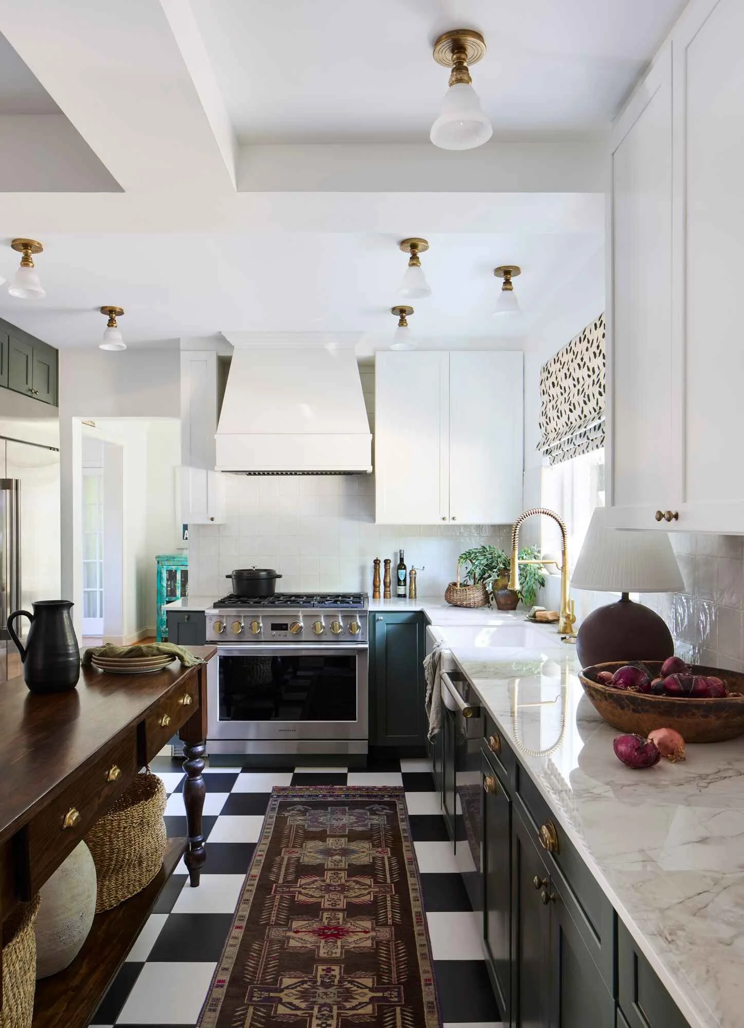 White kitchen hood and brass flush mount lighting