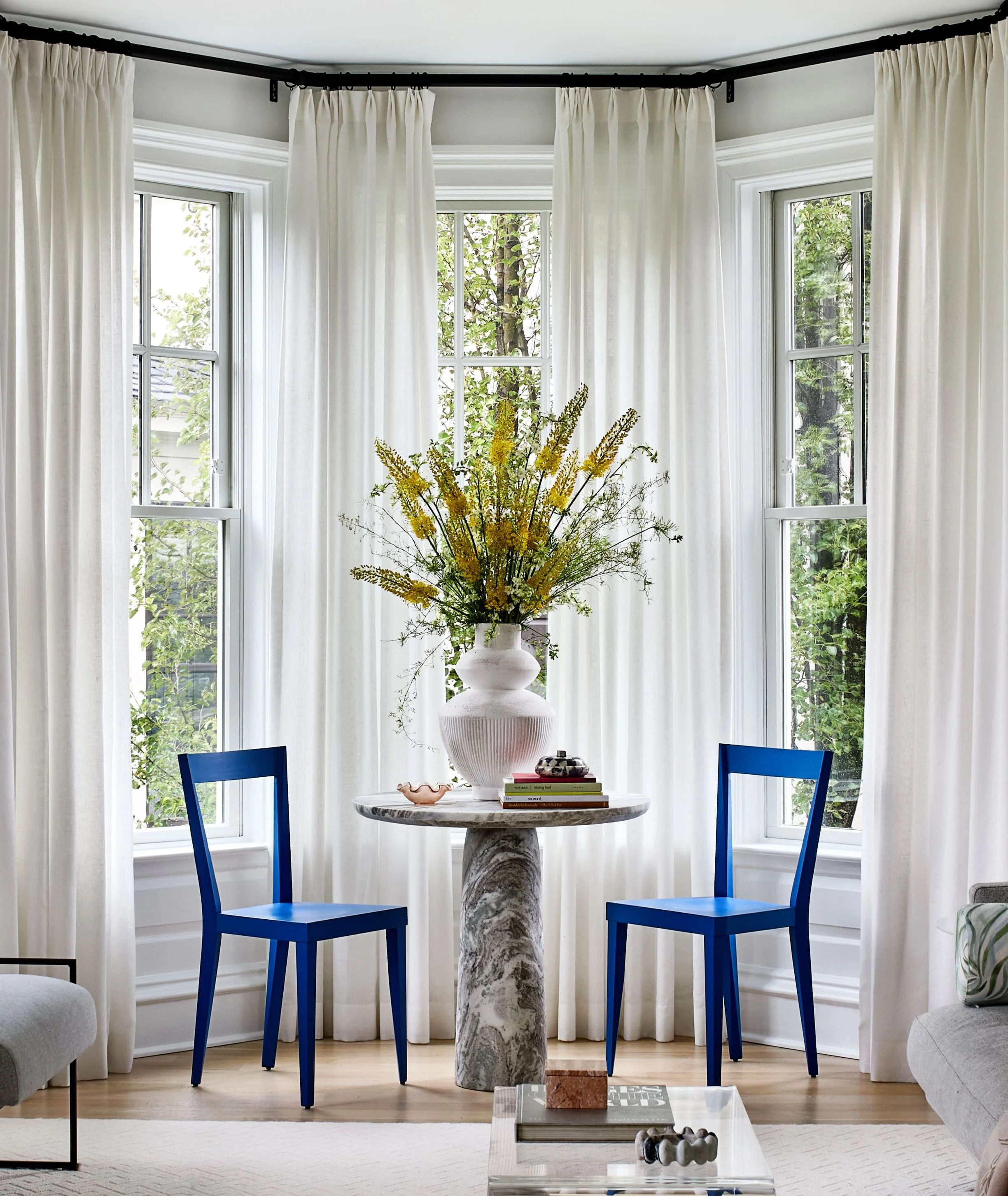 Pop of color with blue chairs in white room 