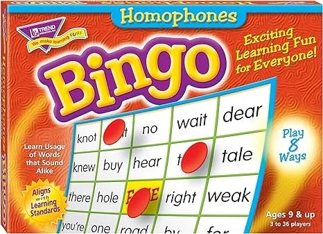 Bingo game card titled "Homophones" with words and red circles marking selected words, and text indicating it is for ages 8 and up with 3 to 36 players.