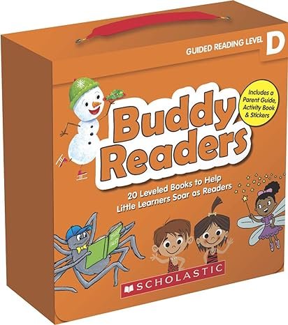 Orange box with red handle labeled 'Buddy Readers' and 'Guided Reading Level D'. Features a snowman, a blue spider reading a book, and three children, one with wings, on the front. Includes a label mentioning a parent guide, activity book, and sticke