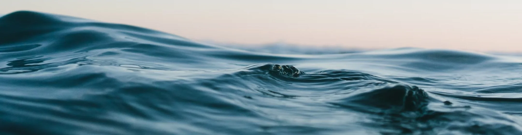 Close-up of ocean waves with gentle ripples and a calm surface.