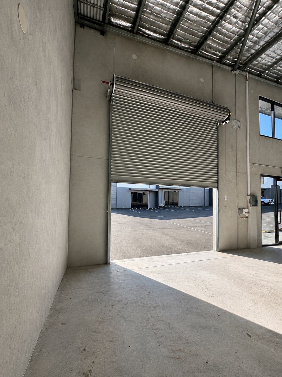 Interior of Southlink Denmark industrial warehouse featuring oversized roller door access and high-clearance concrete construction.