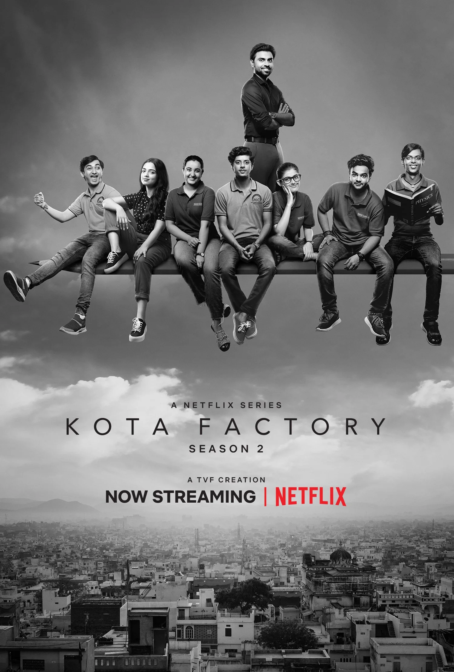 Promotional poster for Kota Factory Season 2 featuring a black and white image of all the kids from the show sitting on a beam above a cityscape. Text reads "A Netflix Series, KOTA FACTORY, Season 2, A TVF Creation, NOW STREAMING, NETFLIX." 