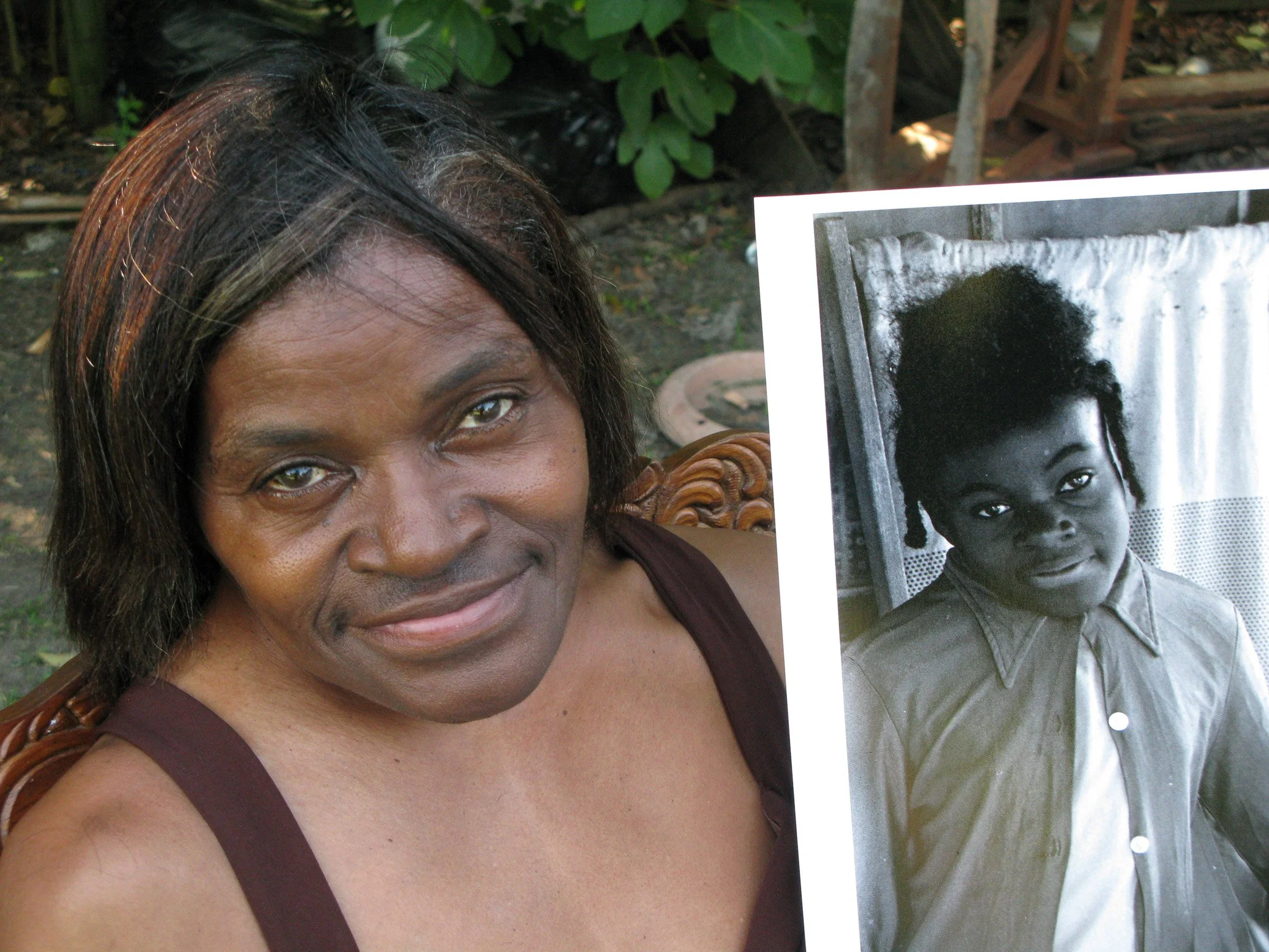 Chrystelle Magee holding a portrait of her younger self