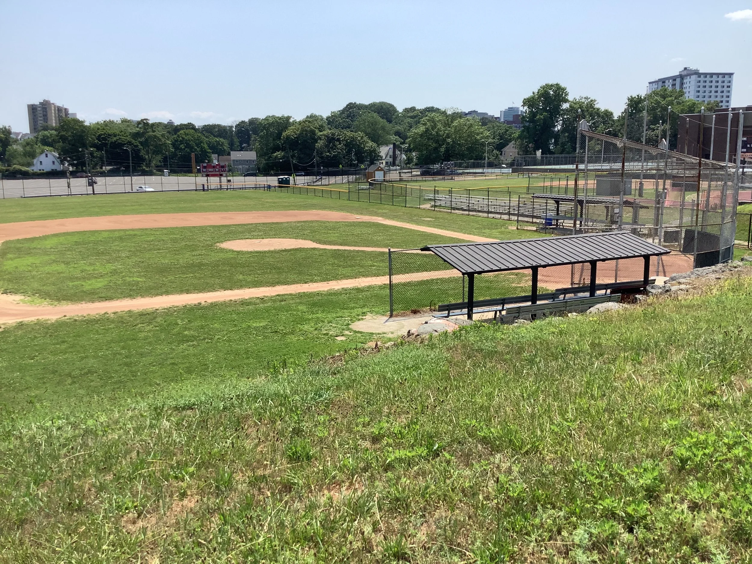 Before shot of SHS baseball field with dugout and fencing on the perimeter.
