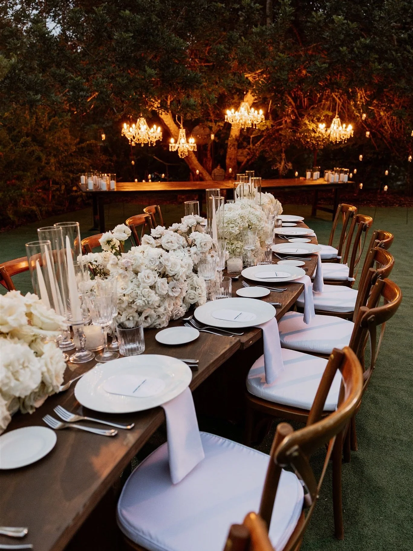 A candlelit feast beneath a canopy of ancient trees, where crystal chandeliers floated in the branches and floral arrangements cascaded in soft ivory tones.

At Fincadelica San Lorenzo, a wedding defined by modern elegance and Balearic romance unfold