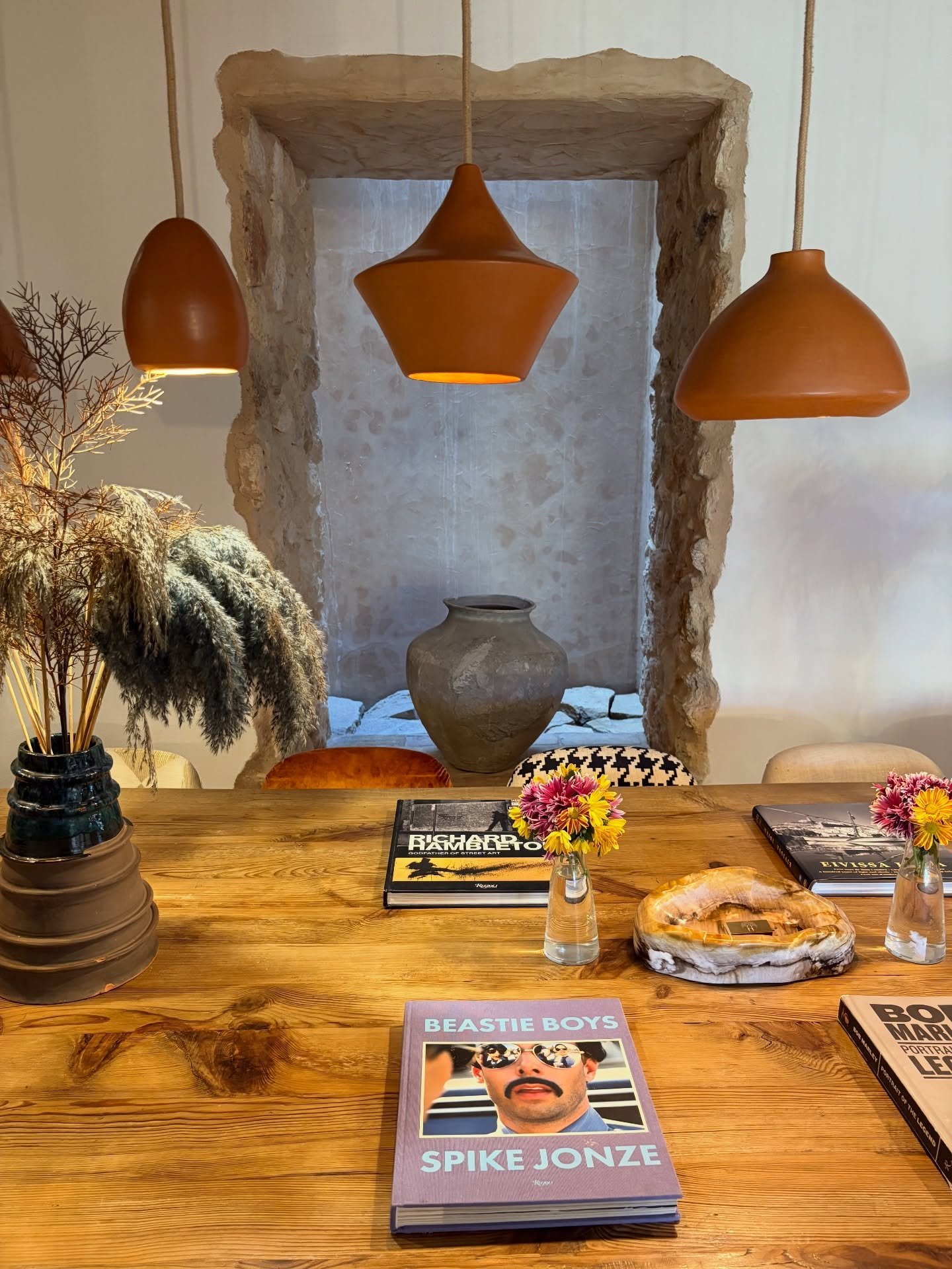 Where conversations linger long after the plates are cleared.

A table designed not just for dining, but for gathering, for shared stories, late nights, and slow mornings. 

Warm woods, sculptural ceramics, and soft lighting create a space that feels