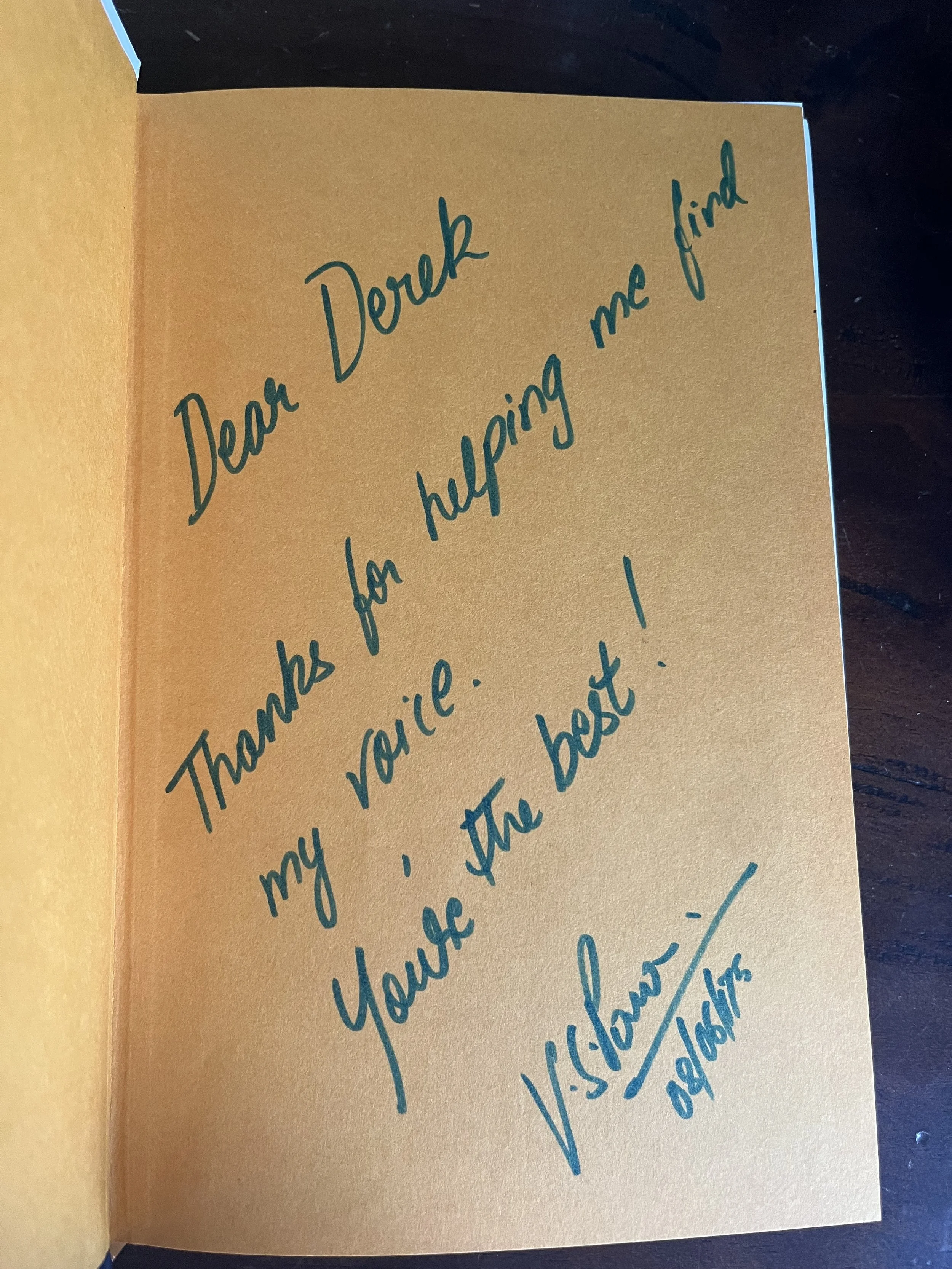 A handwritten note on a golden-colored card expressing gratitude and appreciation.