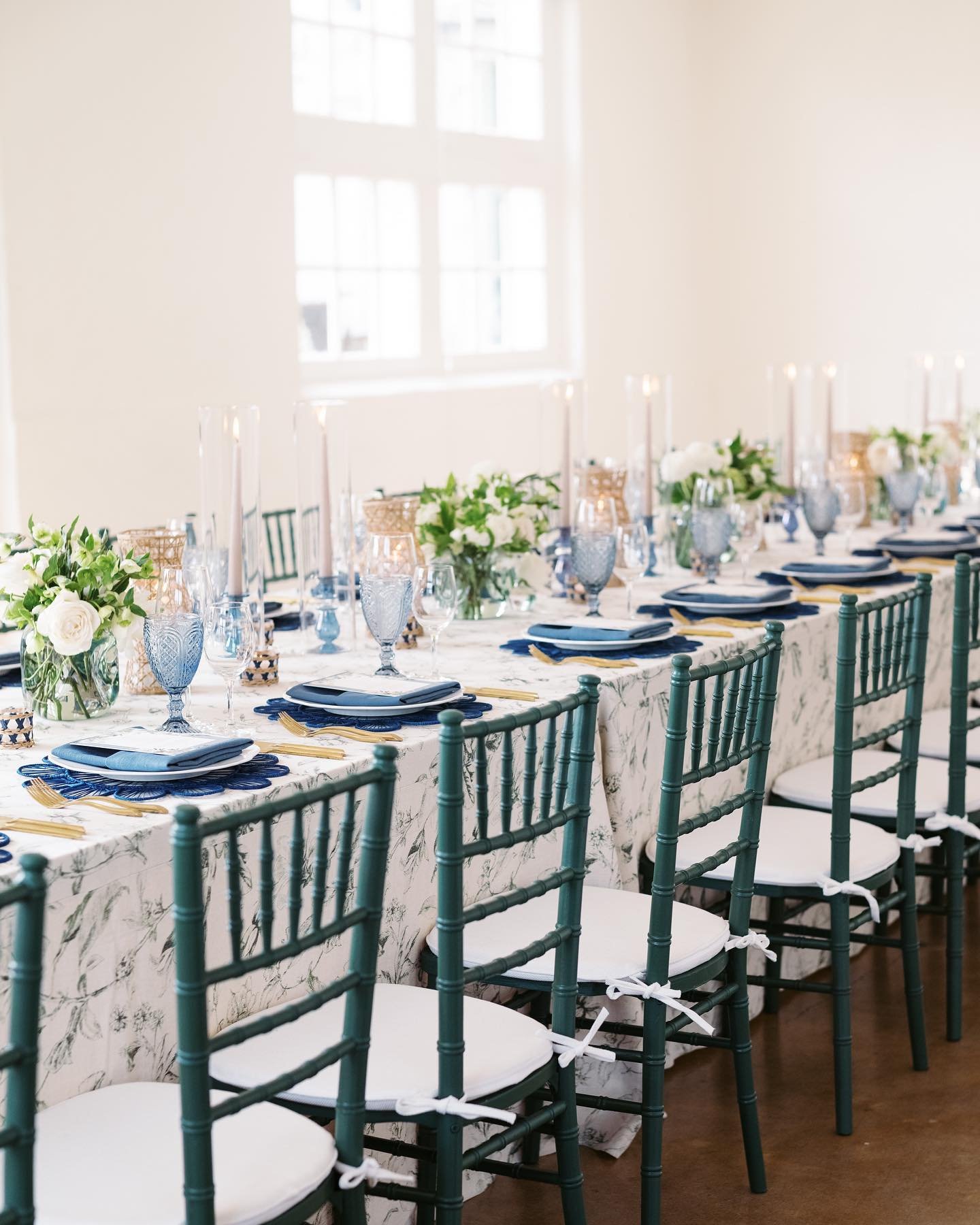 No matter how often we&rsquo;re tasked with designing an event in a classic blue and green palette, we&rsquo;ll never stop finding ways to make it interesting. 

Case in point: those chairs in a standard wood stain, gold or white finish would have be