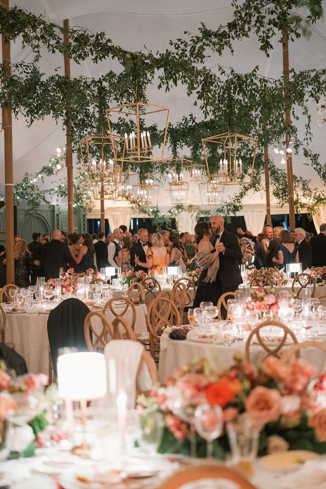 A tented wedding reception with floral design by Rebecca Rose Events