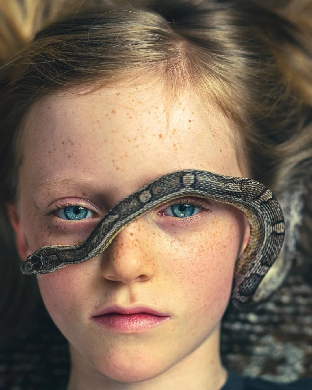 📷 Beauty Illuminated Exhibit
&ldquo;Shadow II&rdquo; by Emily Fisher @emilyfisherphoto 

A portrait where calm meets the wild.
the softness of youth traced by the silent curve of a serpent.
Light reveals what words can&rsquo;t:
courage in stillness,