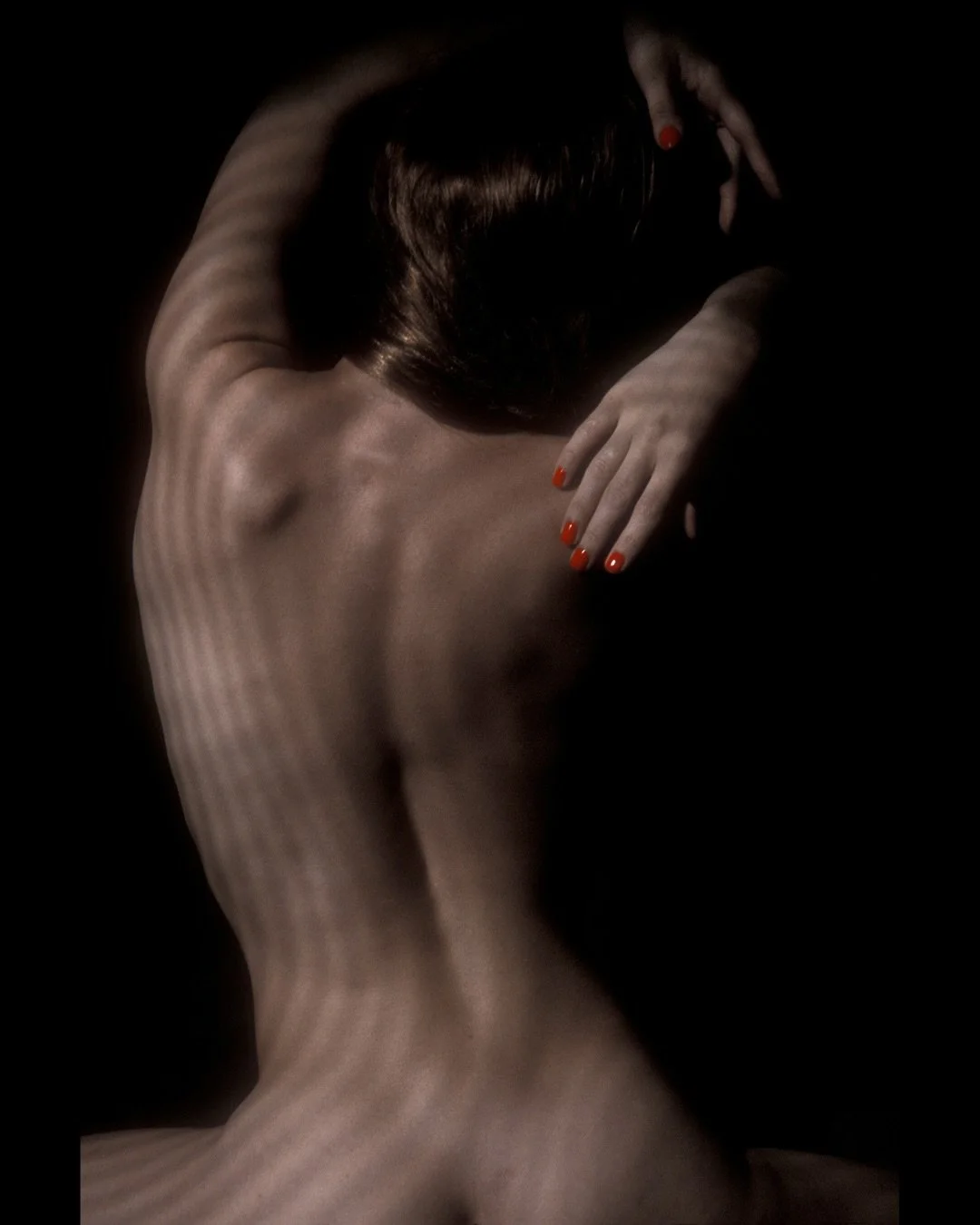 📷 lightvisions Exhibit
&ldquo;Light Shadow and Form 31&rdquo; by Mark Sharfman

Contour, muscle, and soft red nails flicker through bands of shadow &mdash; the body becoming sculpture where light chooses what to reveal.

🖤 Our new call for entry is