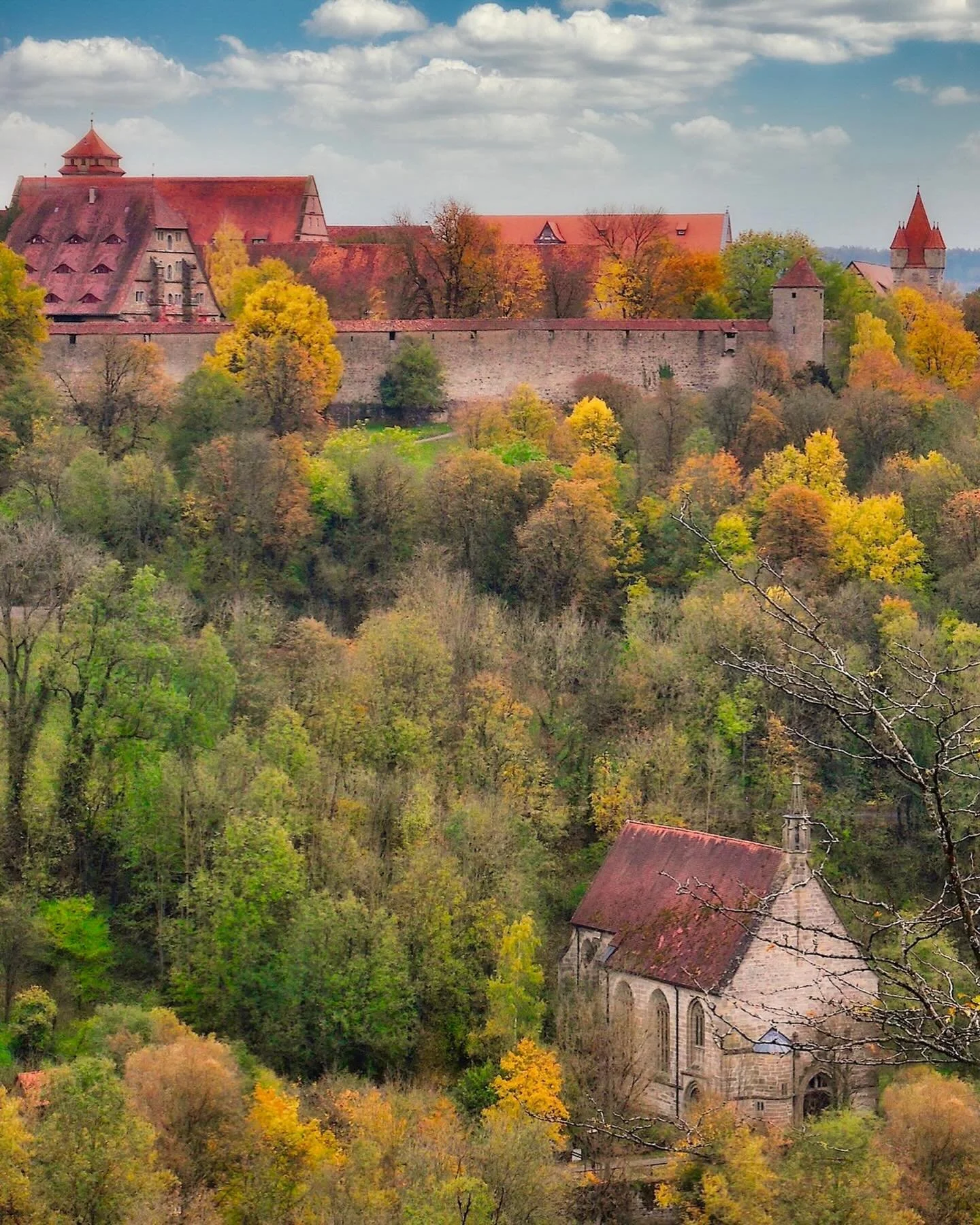 📷 From our Travel Dreams Exhibit
&ldquo;Little Church&rdquo; by M.E. Wilcox

A small structure rests in the folds of the land, almost dissolving into color and season. Stone and roof echo the hues of the trees, as if the church has grown from the hi
