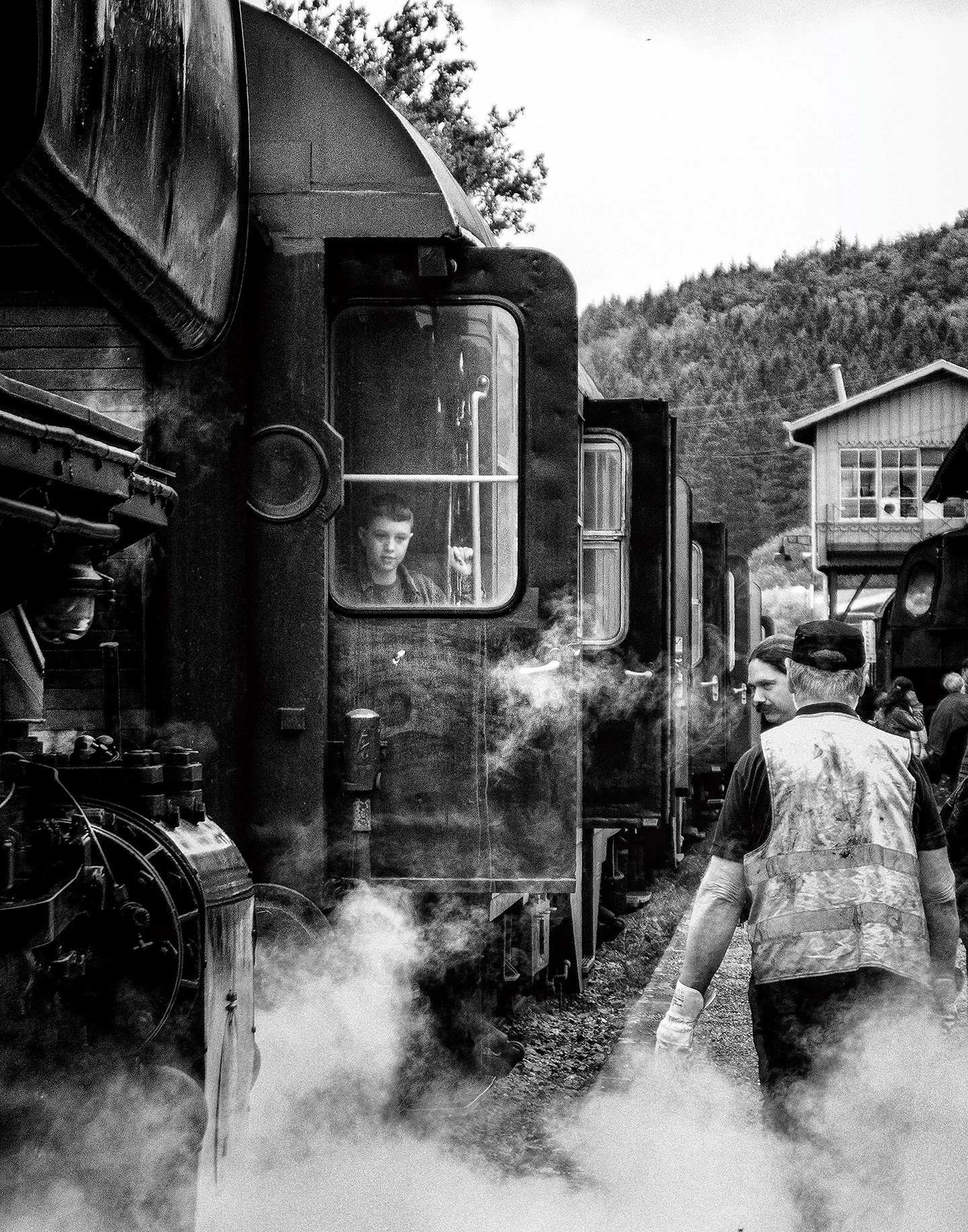 📷 B&amp;W: The Poetry of Light &amp; Shadow
&ldquo;Imagine&rdquo; by Nicholas Nicola

Steam drifts between generations.
A boy watches from inside the train &mdash; framed by glass, suspended between departure and possibility. Outside, a worker moves