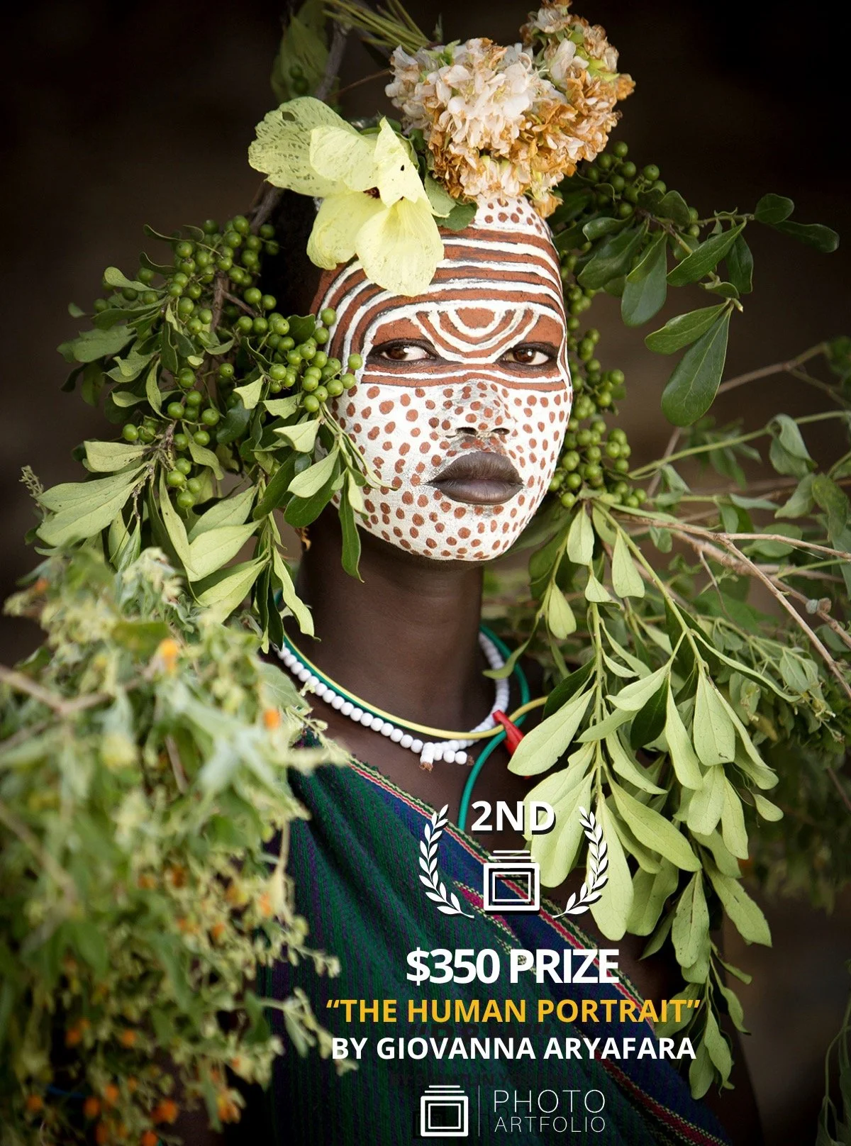 📷 THE HUMAN PORTRAIT
2nd Place
&ldquo;Selina &ndash; Young Suri Girl&rdquo; by Giovanna Aryafara (@giovannaphotography)

A presence that feels both grounded and otherworldly.
Eyes steady. Silence alive.

Adorned with earth, leaves, and patterns that