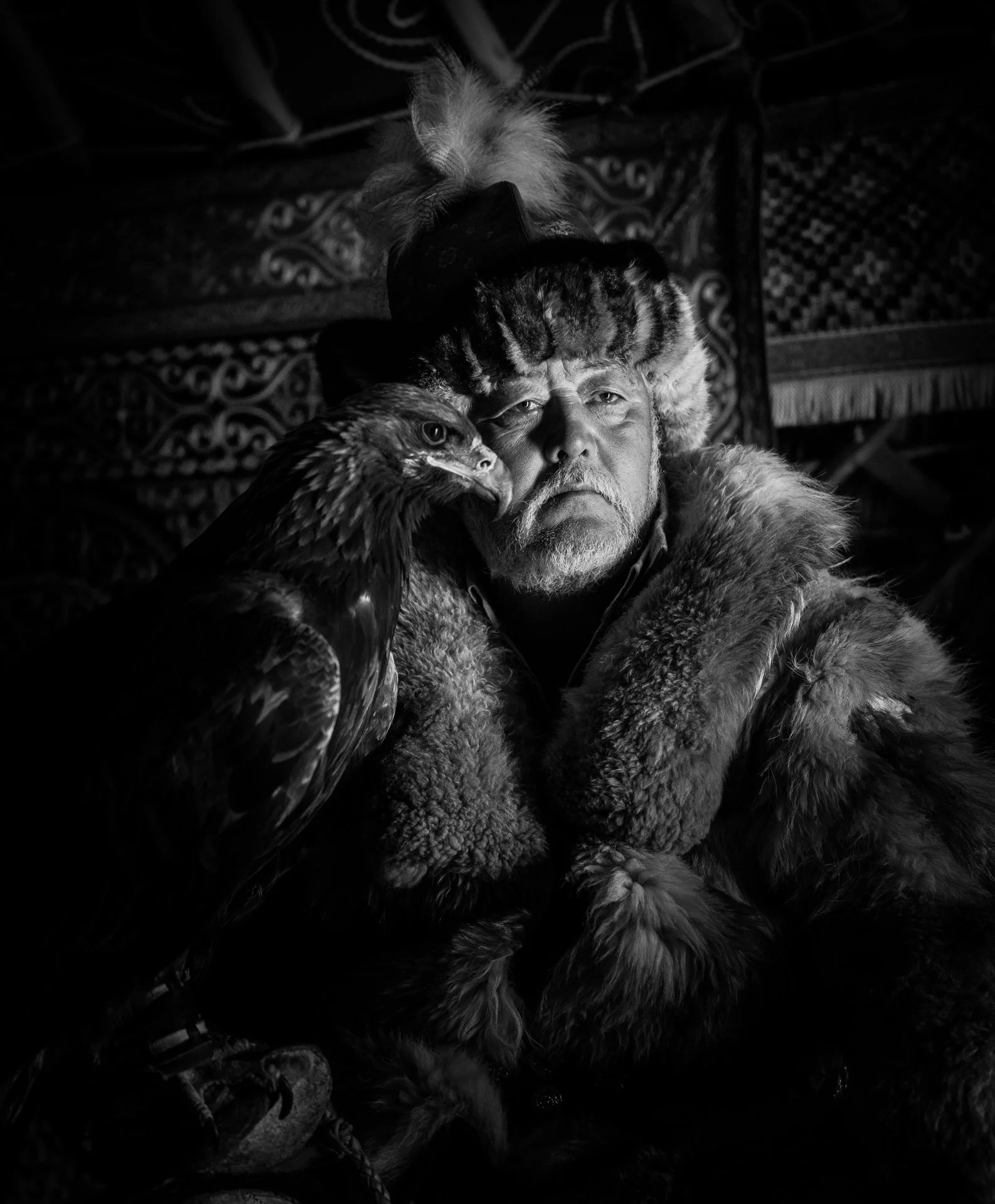 "Eagle Hunter Portrait with Eagle" by Bill Saltzstein 