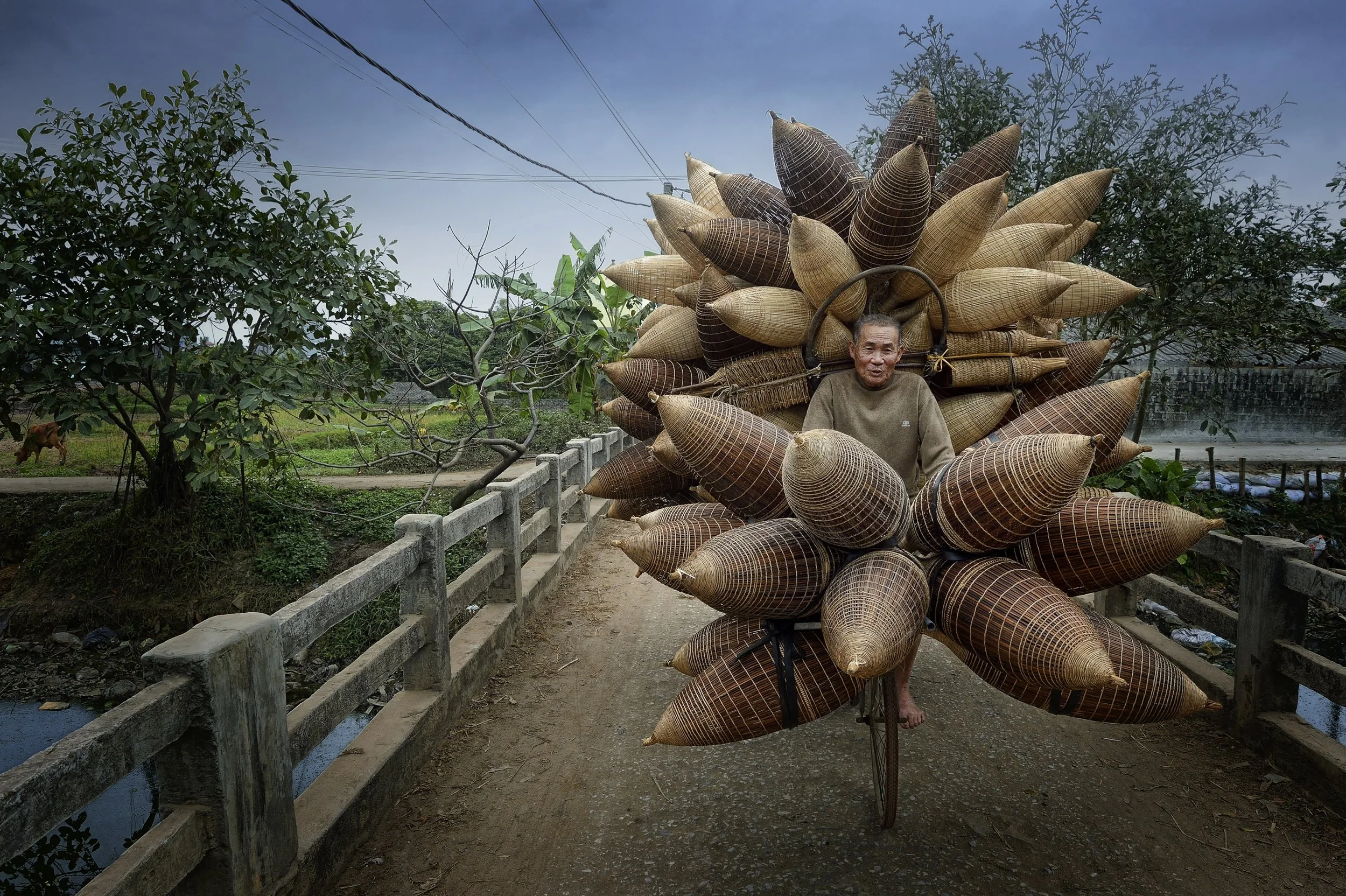 "Bamboo Basket Seller" by Hoang Long Ly