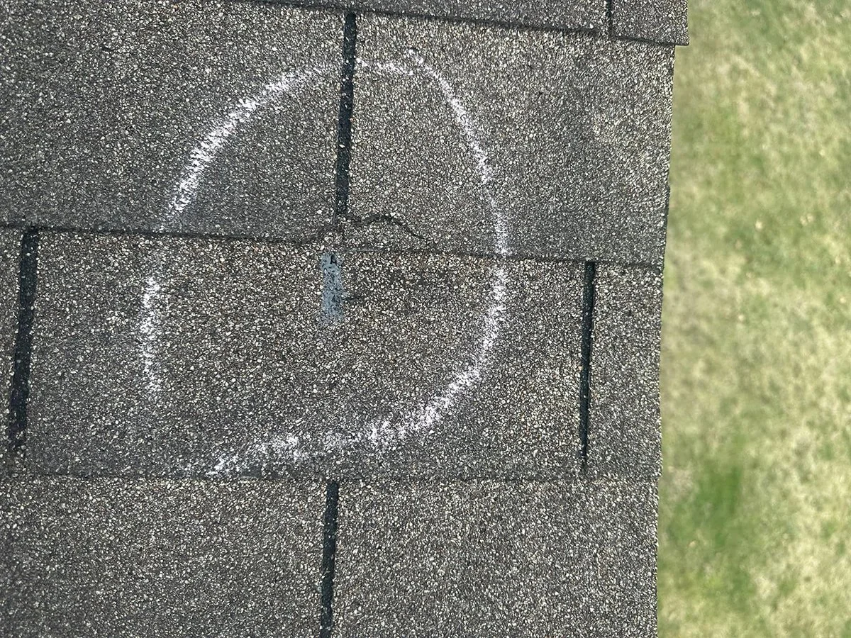 A photo of roof damage found during an inspection that is documented and used to facilitate a roof insurance claim on this home in Cincinnati, Ohio.