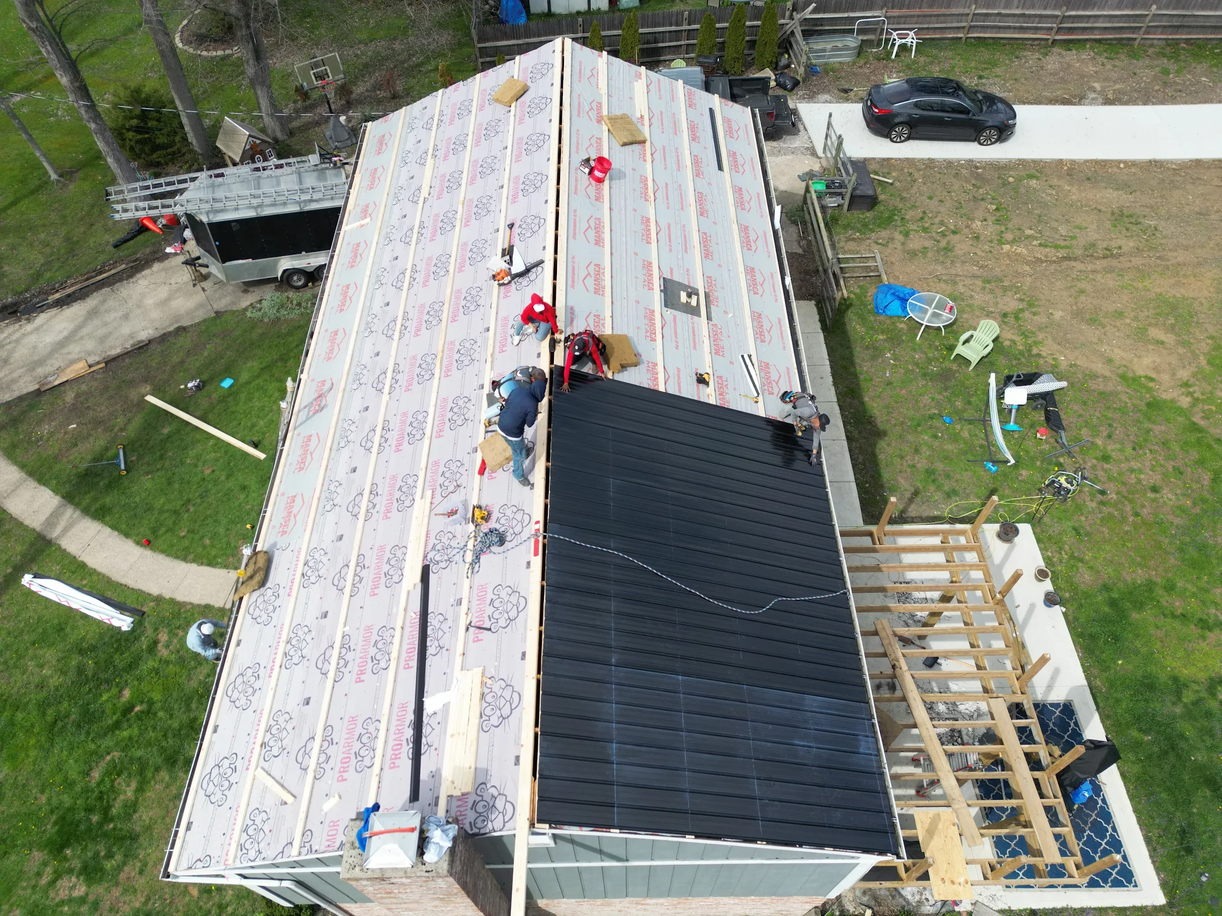 A Riegler Contracting crew installing a metal roof on a customer's home.