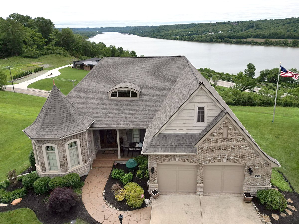 A photo of a new roof installed on a residence in Cincinnati, Ohio with the Ohio River in the background.