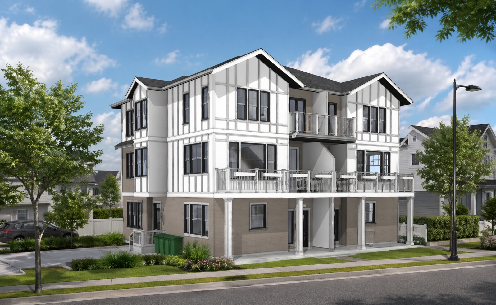 Modern multi-story residential building with white and brown exterior, black-framed windows, balconies, surrounded by green trees and grass, with a blue sky and clouds in the background.