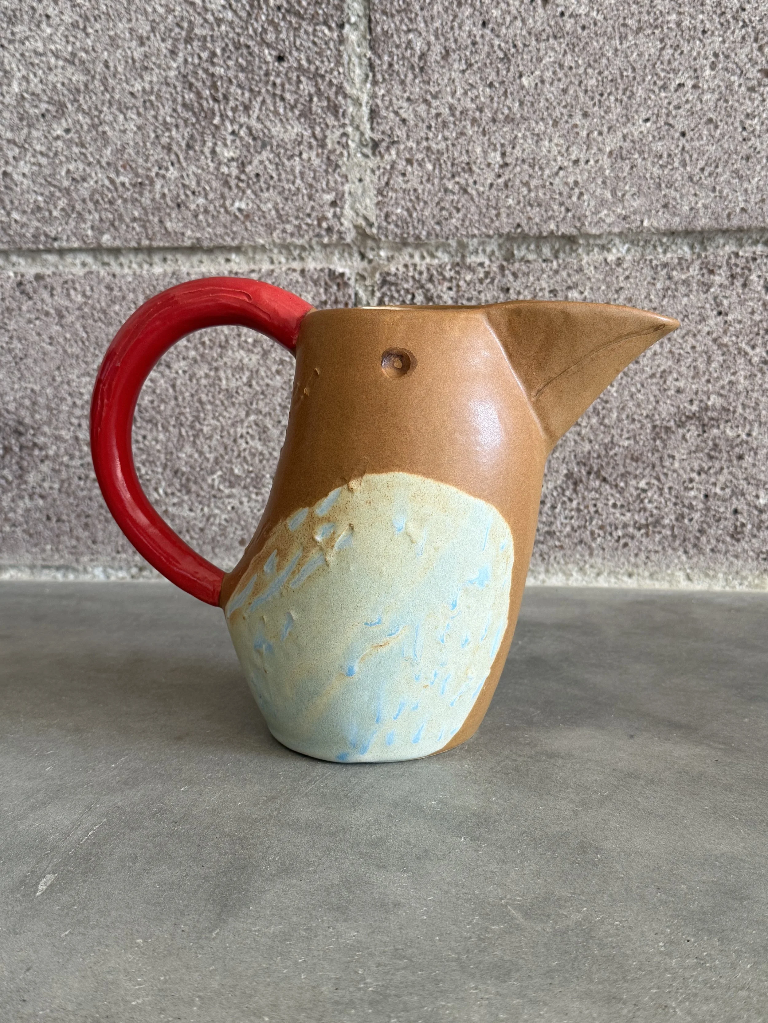 Bird pitcher with red handle