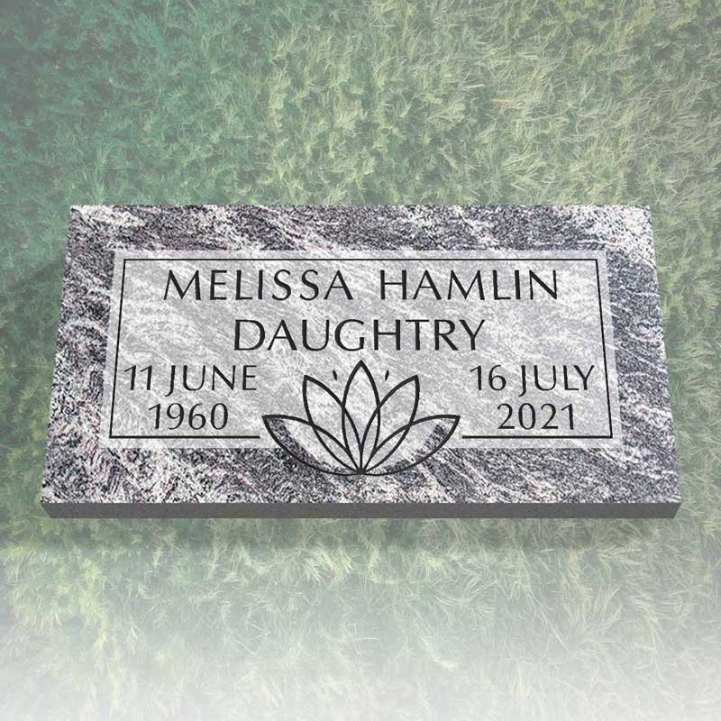 Gravestone for Melissa Hamlin Daughtry with birthdate June 11, 1960, and death date July 16, 2021, featuring a lotus flower engraving.