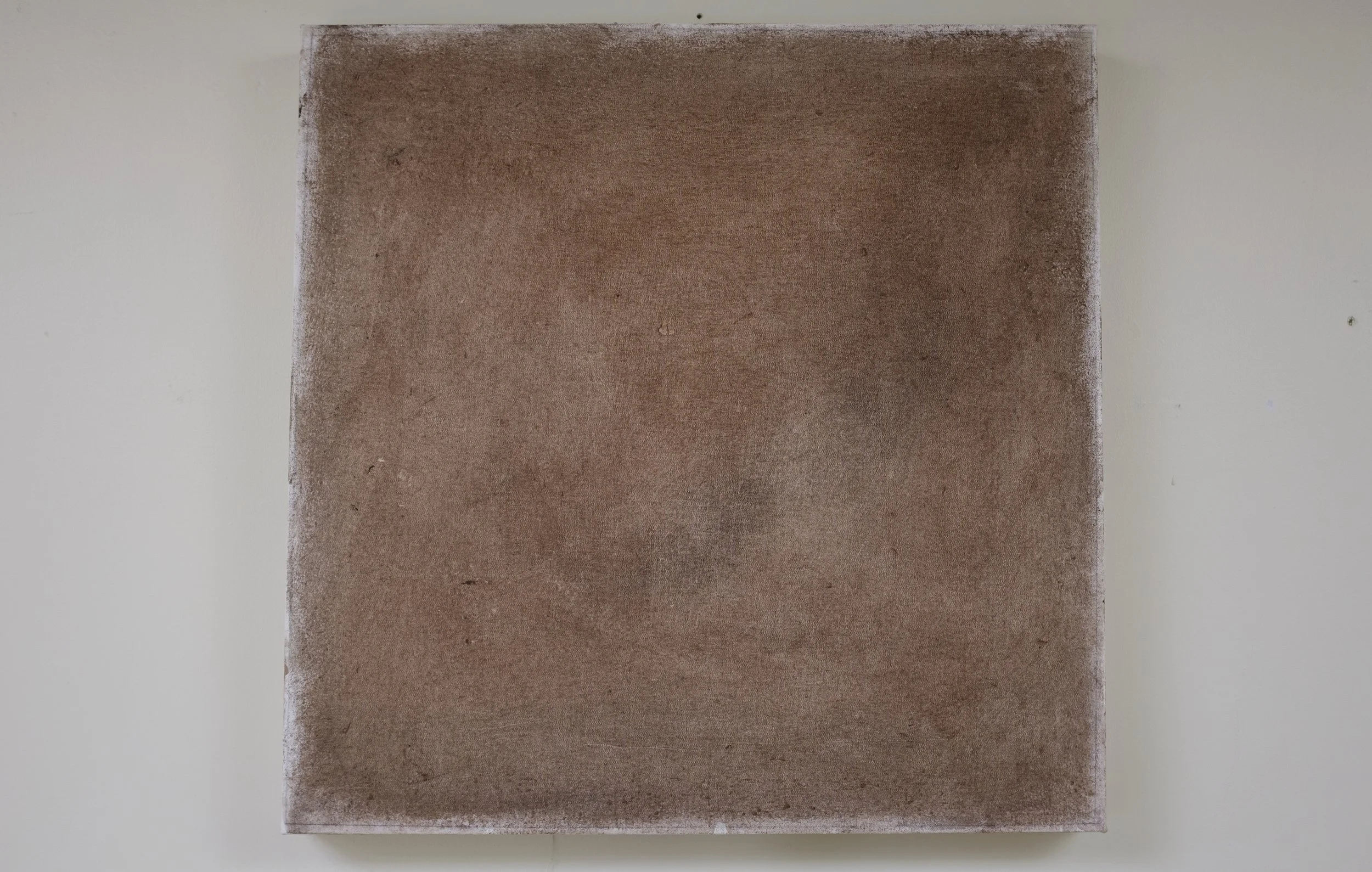 A brick wall with a painted or textured surface.