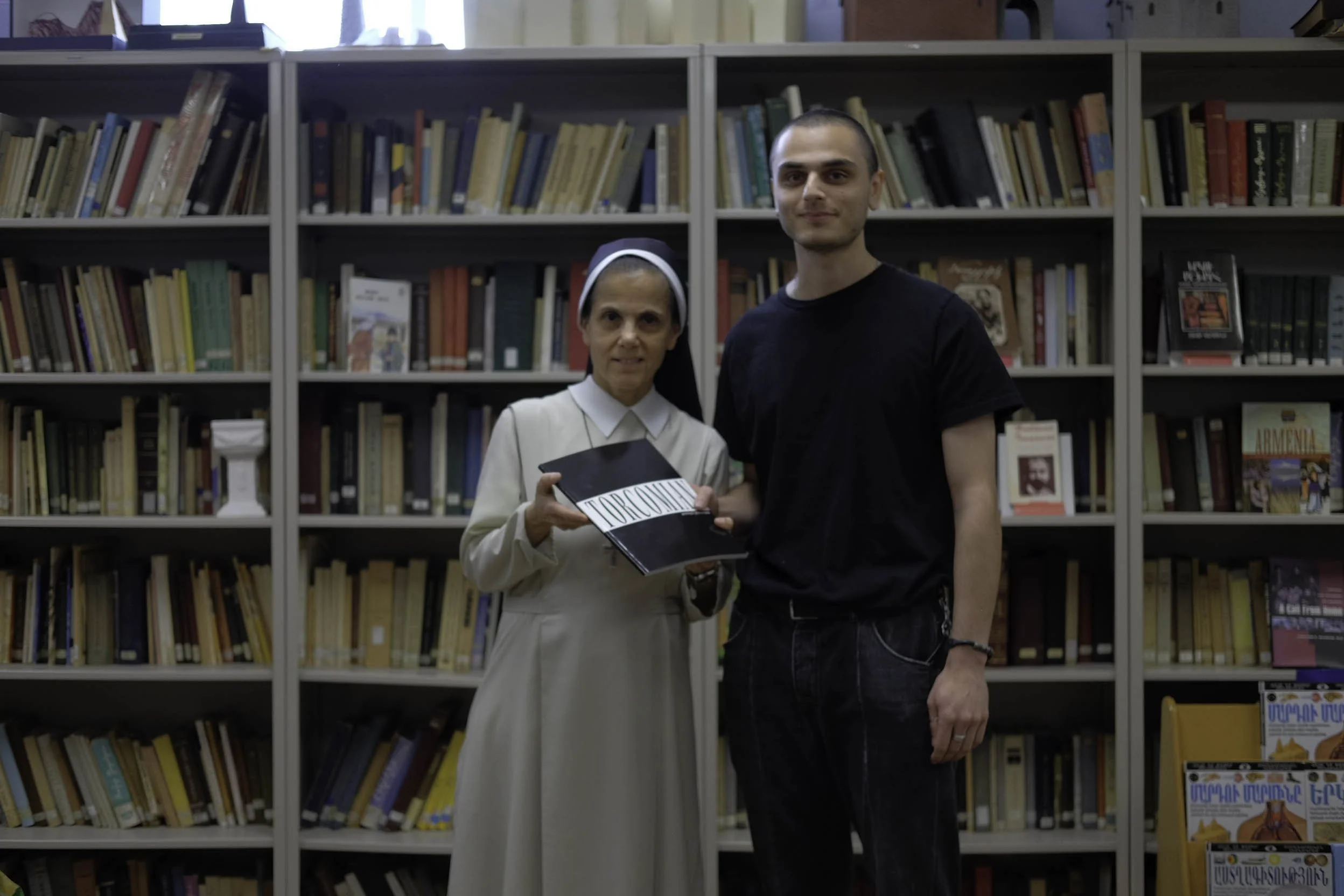 Sister Emma Moussayan accepting book donation from Adam Torcoman to their Armenian Sisters Academy library, 2023