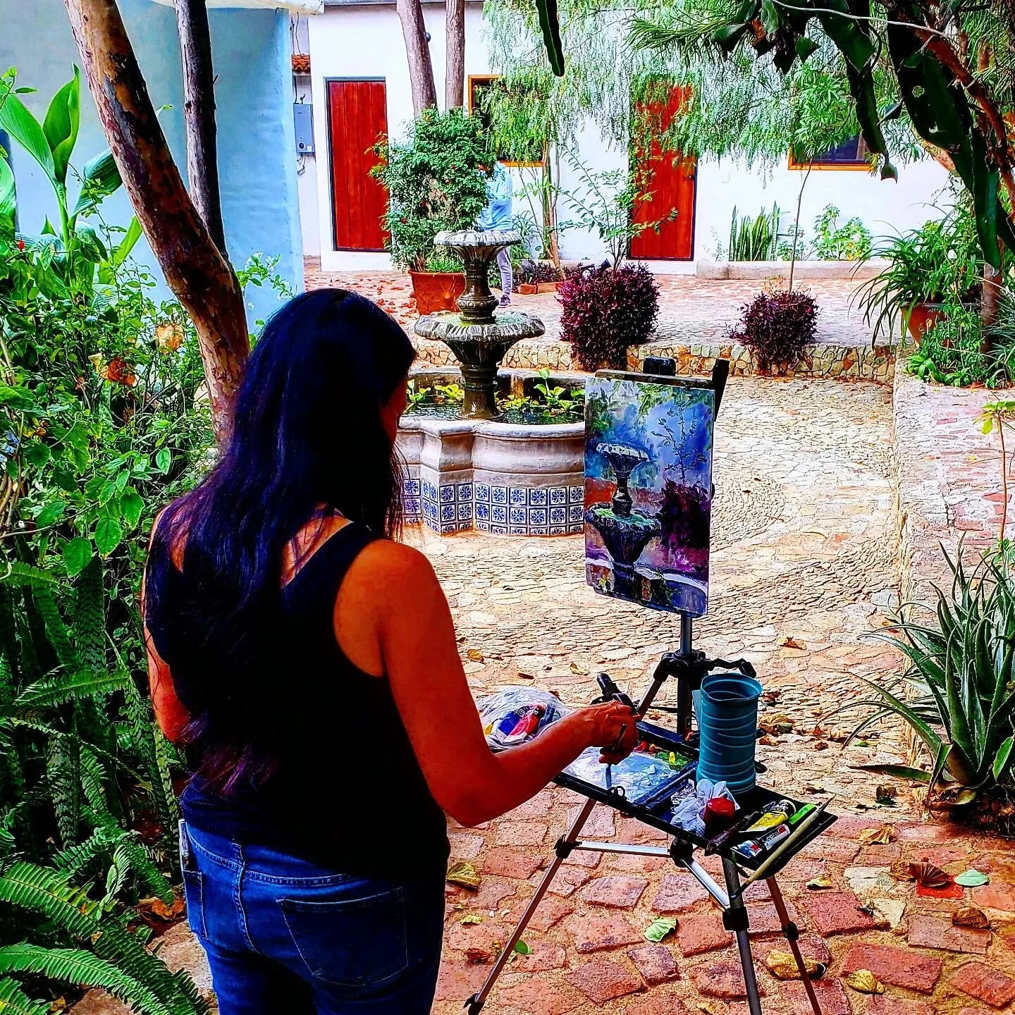 Artist @artworksbymarthadiaz painting at the Oaxacan home of @liladowns.